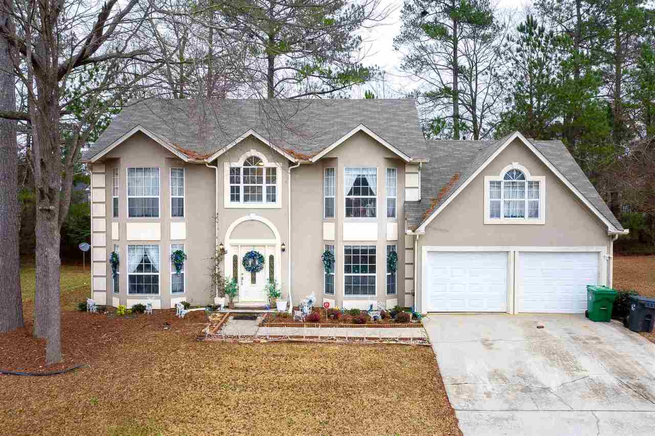 Lots of space with this 5 bedroom, move in ready home! New large deck made for entertaining makes it easy to enjoy the beautiful Georgia weather. This home has a full bathroom and bedroom on the main. The kitchen opens to the breakfast area that overlooks the family room with a cozy fireplace. Separate living room, dining room and family room. Come take a peek to see all this room.....