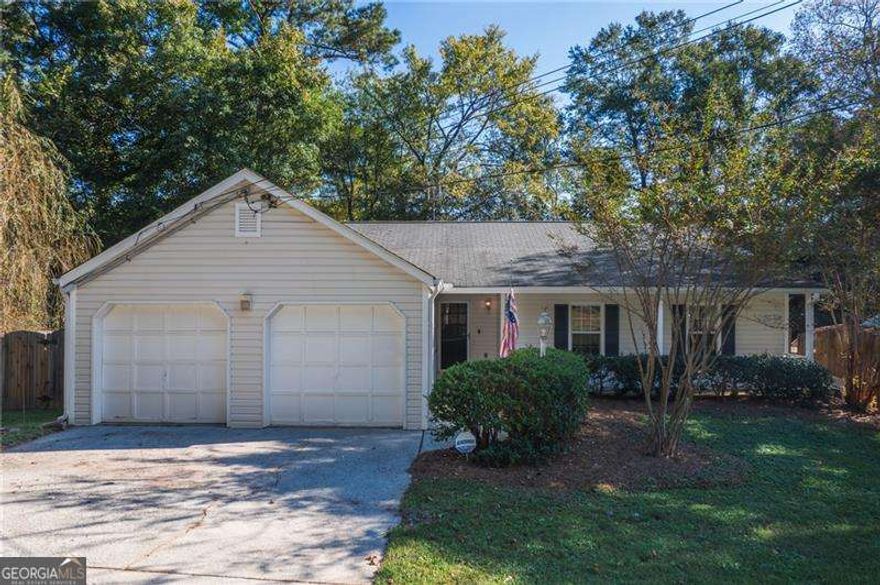 **Great Opportunity in River Oaks - Priced to Sell!**    Don't miss this incredible value in the sought-after **River Oaks** community - **check the comps!** This home offers solid bones and tons of potential with a little TLC to make it truly shine.    Step inside to a **spacious great room** featuring a dramatic **cathedral ceiling**, cozy **fireplace**, and built-in **bookshelves** - the perfect space for relaxing or entertaining. The **open-concept kitchen** flows seamlessly into the great room and includes a **generous eat-in breakfast area**, **tile countertops**, and a **pantry** for ample storage.    Offering **three bedrooms** plus a versatile **bonus room** ideal for a home office, playroom, or guest space. The **primary suite** features a well-appointed **master bath** with **his and hers vanities** and all bathrooms include classic **tile flooring**.    Enjoy the outdoors on a **huge deck** overlooking a **fenced backyard**, ideal for pets, kids, or weekend gatherings. A separate **outbuilding** provides **extra storage** or workshop potential.    Located in a **top-rated school district** and just minutes from **restaurants, shopping, and Downtown Woodstock**, this home offers both convenience and value.  Price Reflected is AS-IS