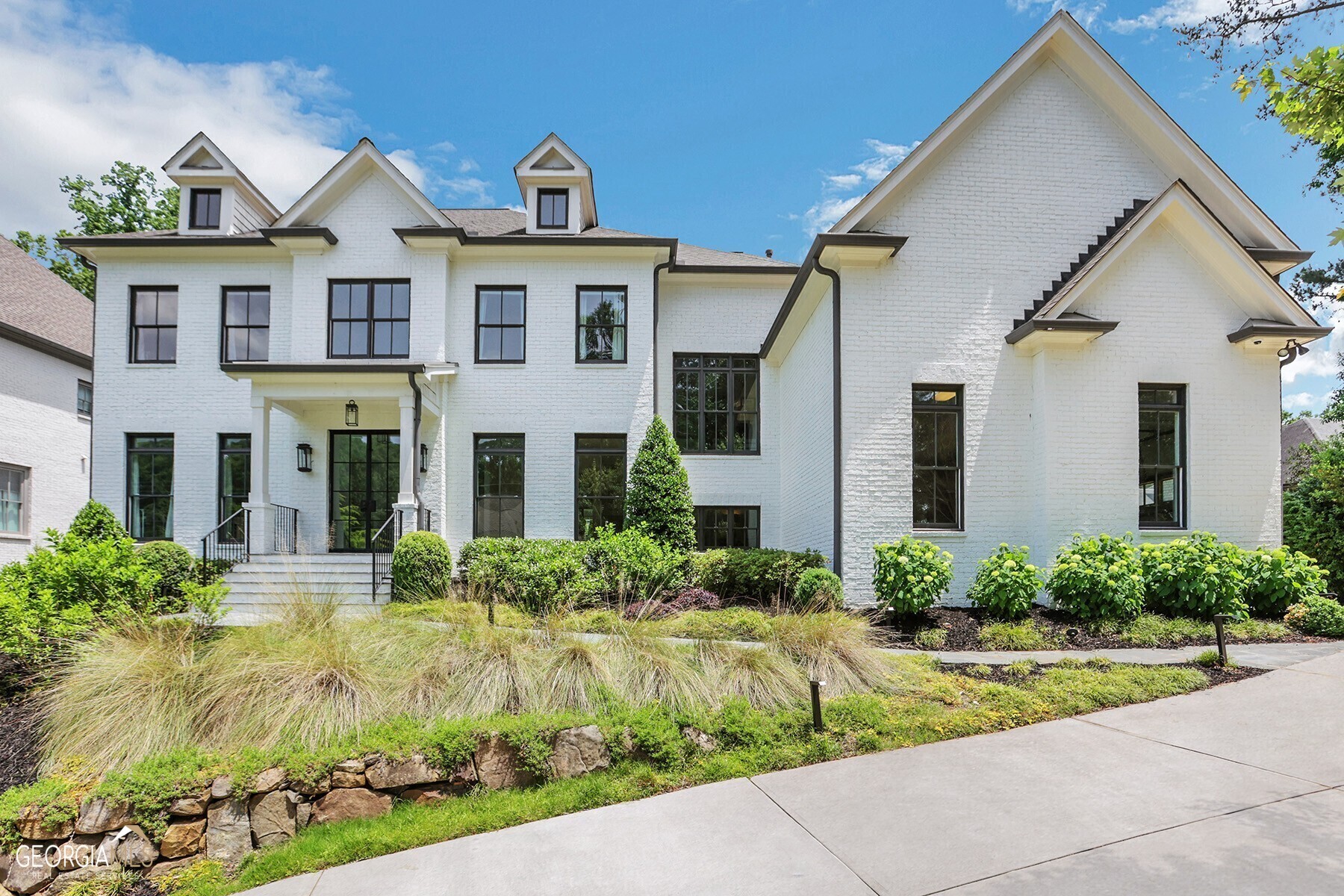 Welcome to 4571 Dudley Lane, a stunning newer construction home in Chastain Park. This home seamlessly blends classic elegance with modern luxury for an exceptional living experience. The open living area boasts high ceilings and plenty of natural light, while the chef's kitchen features Sub Zero and Wolf appliances, marble countertops, and a large island perfect for entertaining. The main level includes a formal dining room, temperature-controlled wine storage, guest suite, family room complete with panoramic views of the private backyard oasis with an impressive attention to detail throughout. Escape to the master suite, a private sanctuary designed for ultimate relaxation. Features include a generous walk-in closet and a spa-like bathroom, complete with a soaking tub, dual vanities, and a separate shower. The additional bedrooms all with ensuites are equally spacious and offer ample closet space. The walkout backyard has been designed for the ultimate outdoor living experience. The backyard is an entertainer's paradise, featuring a heated pool with a soothing spa an expansive outdoor kitchen with a gas grill, double gas burner cooktop, and even a pizza oven. The backyard also features a fully turfed green space, providing a lush and inviting area for games or simply enjoying the outdoors. Situated in Atlanta's highly sought-after Chastain Park neighborhood, this home offers convenient access to the city's finest amenities. From upscale shopping and dining to renowned schools and cultural attractions, everything you need is just a short distance away.