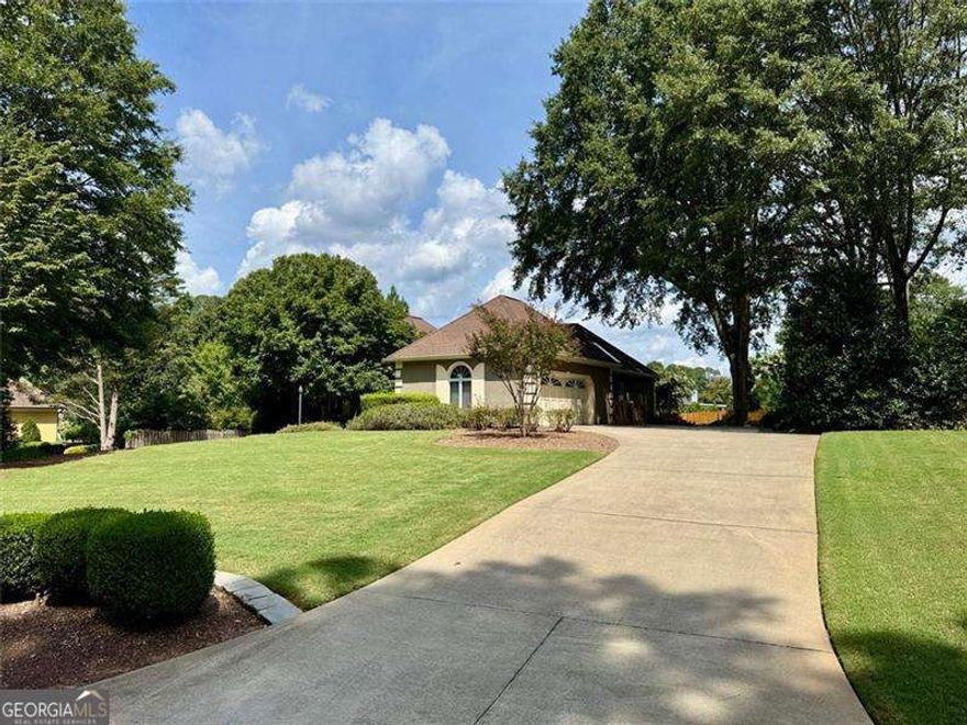 Welcome to 5935 Polo Drive - one of the most affordable homes in the prestigious Polo Golf & Country Club.  This pristine Contemporary European Ranch blends French Provincial elegance with Mediterranean warmth and offers an incredible opportunity to enjoy country-club living at an exceptional value. Set on a beautifully landscaped half-acre lot surrounded by year-round flowering gardens, the home features a stucco exterior, low-pitched roofline, and symmetrical design that create timeless curb appeal. A private secondary driveway offers convenient access or extra parking for a boat.    Inside, cathedral ceilings, skylights, and elegant arched transom windows fill the home with natural light, creating a bright and inviting atmosphere. The great room centers around a beautiful fireplace and features two full-glass double doors that open to a spectacular deck - perfect for outdoor entertaining or quiet relaxation.    Every detail reflects thoughtful craftsmanship, from the refined trim work and wainscoting to the carefully designed floor plan. The spacious primary suite offers double vanities, a soaking tub, and a separate shower, while two secondary bedrooms share a charming Jack-and-Jill full bathroom. A convenient half bath provides extra comfort for guests.    Downstairs, the partial basement includes a large unfinished area with a boat door - perfect for a workshop, hobby space, or finishing into a media room.    Residents of Polo Golf & Country Club enjoy a championship golf course, tennis and pickleball courts, swimming pools, and a welcoming clubhouse surrounded by mature trees. Homes throughout this sought-after neighborhood, especially along Polo Drive, often exceed $1 million, highlighting the remarkable value this home represents.    5935 Polo Drive combines timeless European architecture, natural light, and flexible living in one of Forsyth County's most desirable communities.
