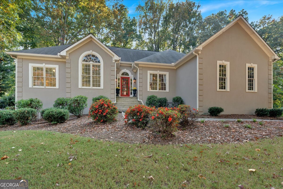 Welcome to your dream home situated in the highly sought-after Lost Mountain Middle/Harrison High School district.   This beautifully maintained residence features a spacious master retreat on the main w/ stunning views of back yard and direct access to screened in porch. Picture yourself with your morning coffee in front of the stacked stone fireplace. Primary bath has double vanity, granite countertops, tile shower, whirlpool tub and walk in closet. Guest room on the main w/ cozy sitting room and full bathroom. Kitchen is open to family room and boasts granite countertops, brand new stainless appliances, spacious dining area and breakfast bar.  Front living room can serve as a library, office or sitting room. Separate dining room large enough to seat twelve...perfect for parties or holidays. Views abound from the kitchen and family room to the screened porch, 2 levels of decks and the park-like setting in the back yard (fenced for plenty of privacy). So much natural beauty and tons of space for grilling and entertaining!   The versatile space in the terrace level includes a theater area, office/workout room, along with ample unfinished space for storage. An additional garage door provides easy access for your boat, lawn equipment, or golf cart.    Recent upgrades include: Recessed lighting in kitchen, all new gutters, added an HVAC system for 2nd level, complete renovation of 2nd level bathroom, new water heater, freshly stained hardwoods throughout main level, new garage doors main level and basement, new porch screening, new tile and sink for main level guest bath, fresh interior paint throughout, new wrought iron mailbox, installed hardwood in laundry room and new carpet/pad throughout. DonCOt miss the brand-new front door, sidelights and transom!    The community offers fantastic amenities including clubhouse, tennis courts, swimming pool, playground, and sidewalks.    This is a must-see property that combines comfort, style, and convenience. Schedule your showing today!