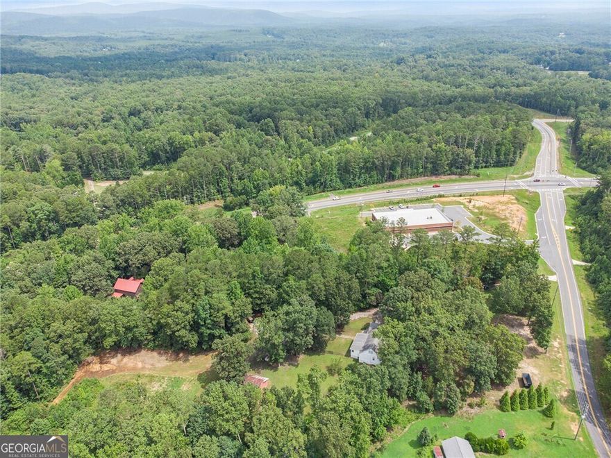 Great opportunity in this rapidly growing Cherokee County. Zoned General Commercial and located at the intersection of GA State Hwy 20 and Hwy 108 (Fincher Rd) between Canton and Cartersville next to newly constructed Dollar General Store..  Lake Allatoona is close by.  Adjacent properties are also zoned general commercial with possible opportunity to assemble other tracts. This would be a great location for a gas station, storage facility, dry storage for RV's and boats, etc.... possibilities are endless.  There is a farmhouse nestled on this 4.88-acre property in Sutallee that offers the perfect blend of rustic charm and commercial potential. With 4 bedrooms, 2.5 bathrooms, and a spacious 3,000 square feet, this property is a true gem. Step inside and be enchanted by the farmhouse's inviting ambiance, complete with a cozy family room featuring a fireplace and exposed beams that exude warmth and character. Beyond the charming living spaces, the property boasts a barn, pasture, and an abundance of fruit trees, creating a picturesque mini-farm setting. But the real draw is the property's commercial zoning, making it an exceptional opportunity for those seeking to establish a thriving business in a serene, countryside location.