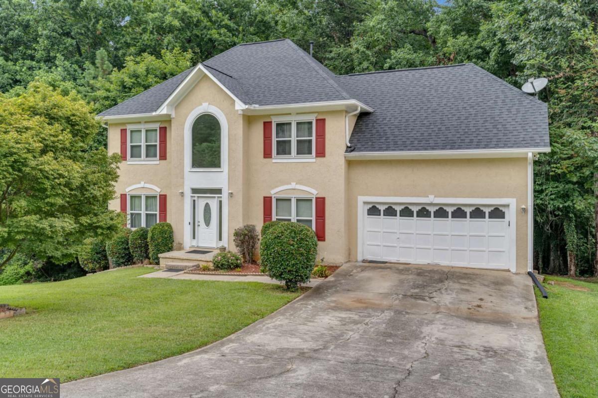 This hidden gem nestled on an expansive 3.52-acre PRIVATE LOT in the heart of East Point. This spacious 4-bedroom, 2.5-bath traditional home offers over 2,400 square feet of comfortable living space and endless potential inside and out. Tucked away in a quiet, established neighborhood, this property provides rare privacy just minutes from downtown Atlanta, Hartsfield-Jackson Airport, Tyler Perry Studios, and major highways. Step inside to a classic two-story layout featuring a bright and airy living room, separate dining area, and a cozy family room with fireplace-perfect for entertaining or quiet evenings at home. The large kitchen includes ample cabinet space and a breakfast area overlooking the serene, wooded backyard. Upstairs, you'll find four generously sized bedrooms, including an oversized primary suite with a private bath and walk-in closet. Major system updates have already been taken care of with a NEWER ROOF and WATER HEATER, giving you peace of mind and reduced maintenance costs. Enjoy the peaceful outdoors from your expansive backyard-ideal for gardening, a future pool, or even building an additional structure. With over three acres of space, the possibilities are endless. This home also features a two-car garage, ample driveway parking, and central heating and air. Whether you're looking to create your dream estate, invest in land, or enjoy room to grow, this is a rare opportunity in a location that blends convenience and tranquility. Don't miss your chance to own one of the LARGEST LOTS in the area-schedule your private showing today!