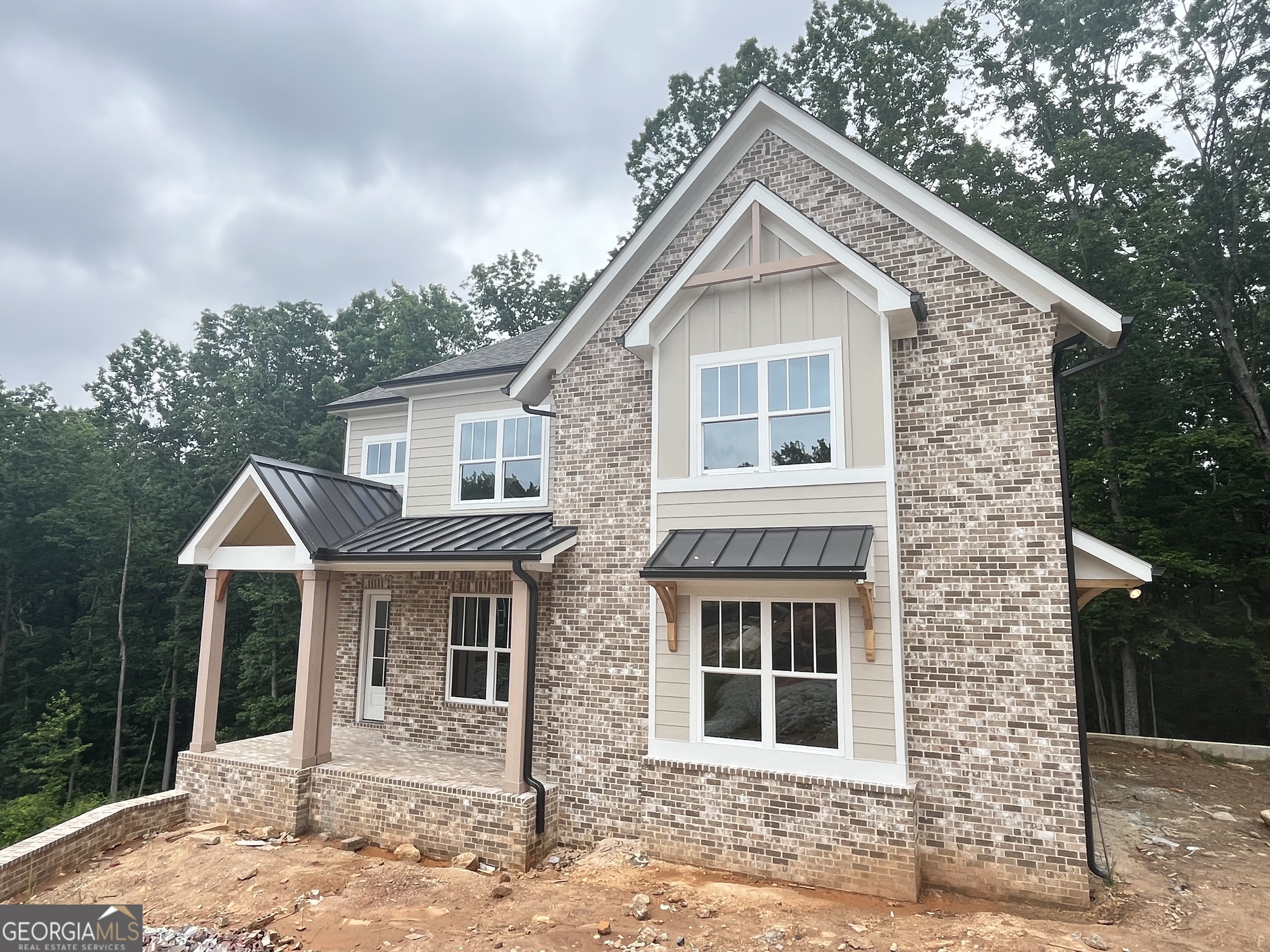 Lot 4 Wesleyan - LAST 2 INAL OPPORTUNITIES - MOVE IN READY Custom home with basement, covered deck and 2 car garage nestled on 1.38 acre cul de sac homesite offering wooded backyard and amazingly large side yard - You'll love living in Liberty Springs, a Woodstock community of only 10 homes on large homesites. You'll enjoy the easy flow of Windsong Properties' popular Wesleyan floor plan on a full unfinished daylight basement. This home offers wide-open living spaces to enjoy with your family and friends. Along with the soaring 10-foot ceilings on main level and 9-foot on second level, this home is decked out with high-end options you won't find anywhere else - quartz countertops, Shrock Entra cabinets, Kitchen Aide appliances, custom tile in all baths, showers and laundry room and a freestanding soaking tub in the owner's bath along with a large tiled shower with frameless shower door. Located in the cul-de-sac on a 1.38 acre lot backing to trees, you'll love the privacy and the large backyard and covered deck. This home offers a large owner's suite upstairs, a Guest bedroom/office and a full bathroom on the main level. The main level bath is finished with a tiled standing shower and frameless shower door for a total of five bedrooms and four baths. Enjoy the open feel as you enter the main level with soaring ceiling heights and cozy up with modern gas log fireplace in Great Room. The second floor has 4 spacious bedrooms, 3 baths (Owners spa bath, a Jack & Jill and an ensuite bath) and a large tiled laundry room with laundry sink. Each bedroom is spacious with generous-sized closets. Exterior photos are of actual home and interior photos are of staged Wesleyan plan at Lot 9.