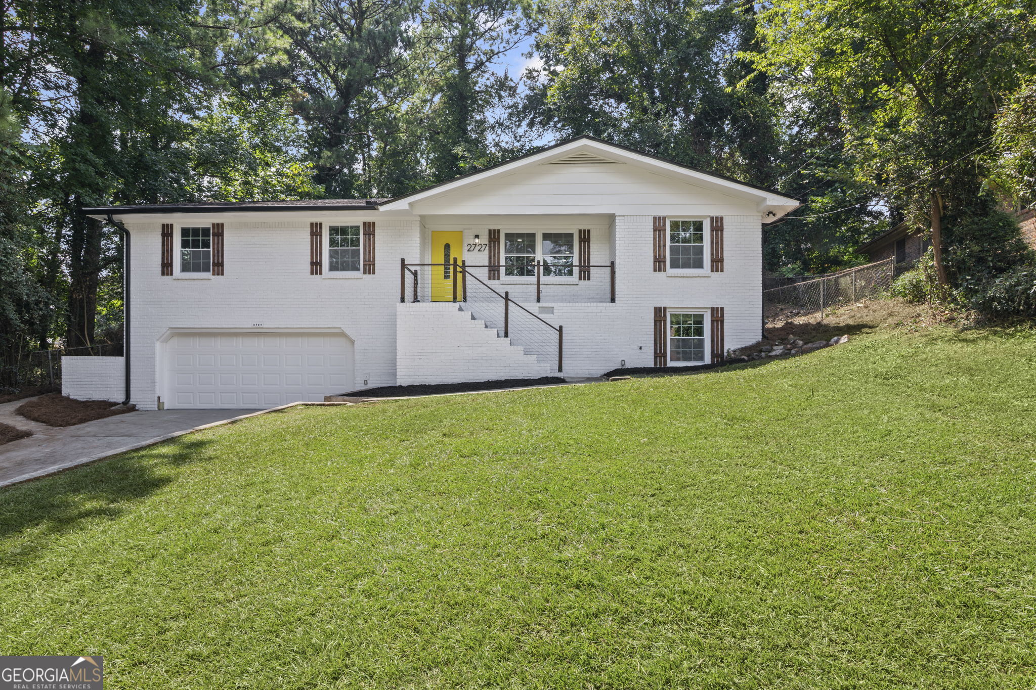 Welcome to this stunning, fully renovated 4-sided brick home in a quiet Decatur neighborhood with no HOA and no rental restrictions-perfect for homeowners and investors alike. This move-in-ready property offers complete peace of mind with all new windows, doors, roof, HVAC, water heater, plumbing, and electrical systems. Inside, you'll find gleaming hardwood floors throughout the main level, an open-concept kitchen with upgraded finishes, new appliances, and beautifully designed bathrooms. The home features 4 spacious bedrooms and 3 full bathrooms, including a luxurious second primary suite in the fully finished basement. This retreat boasts a massive walk-in closet and spa-inspired bathroom with a freestanding tub and shower combo, double vanity, and high-end tile work. The basement also includes a mud room, wet bar, kitchenette, laundry area, and durable new LVP flooring-ideal for guests, in-laws, or rental income potential. Enjoy outdoor living in the huge, flat backyard with plenty of space for entertaining, gardening, or play. A 2-car garage adds convenience and storage. With modern updates throughout and a truly maintenance-free lifestyle, this property is a rare find that combines comfort, function, and investment potential.