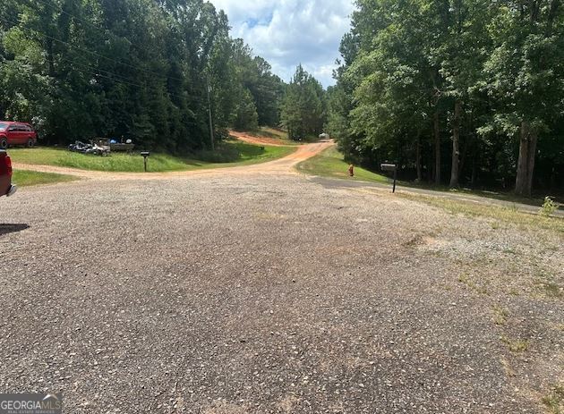 Come enjoy nature and build your own private retreat. No HOA. Site built or mobile homes allowed. This property sits at the end of a street. Very quiet and peaceful. Lot has a driveway and small cleared area for homesite.