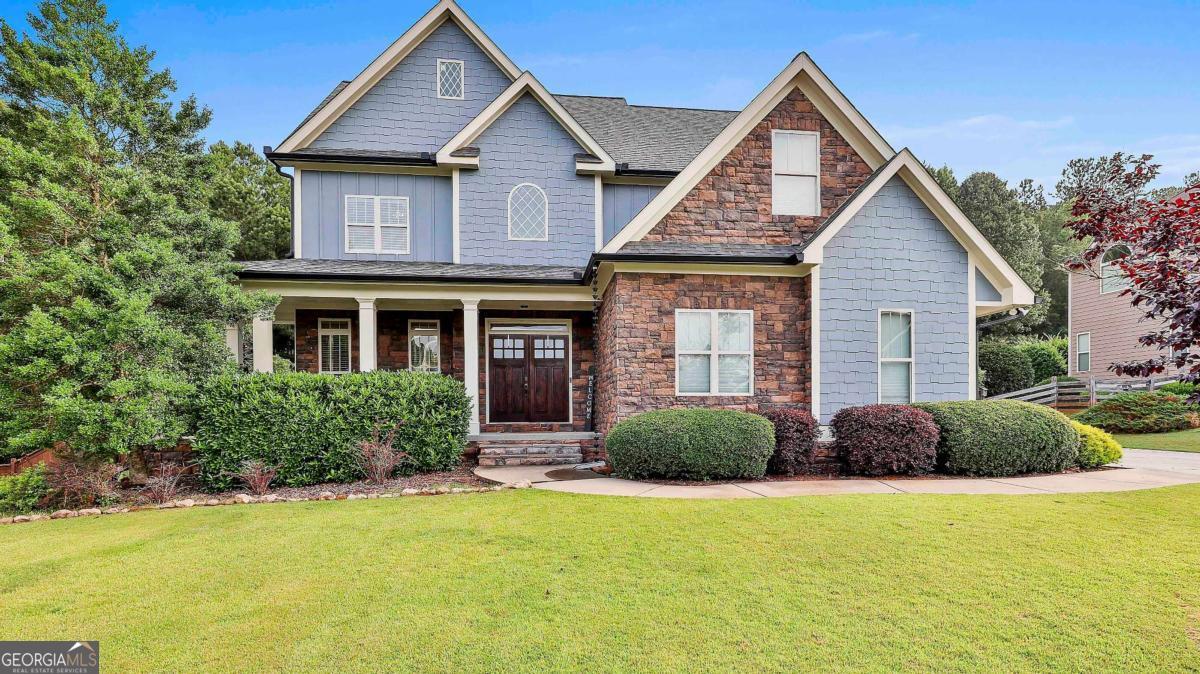 *Custom Craftsman Home Steps from Historic Downtown Senoia* Welcome to this stunning 4-bedroom, 3.5-bath custom Craftsman home, perfectly situated just a quick walk or golf cart ride from the heart of Historic Downtown Senoia. Blending timeless architectural charm with modern upgrades, this home offers exceptional design and comfort throughout. Step inside to discover real hardwood floors, elegant crown molding, and detailed trim work that add warmth and character. The open-concept layout features a spacious kitchen designed for both everyday living and entertaining-complete with granite countertops, stainless steel appliances, and ample cabinetry. The kitchen seamlessly flows into both the keeping room and family room, each centered around its own cozy stone fireplace. A private second office or home gym offers flexibility to suit your lifestyle. The luxurious primary suite includes a spa-like bathroom with tile flooring, a walk-in tiled shower, garden tub, dual vanities with granite counters, and a generous walk-in closet. Upstairs, you'll find two large bedrooms with plenty of closet space and a shared full tiled bath. The third floor boasts a private teen or guest suite with its own full bath and walk-in closet, providing a quiet retreat for visitors or older children. Enjoy outdoor living year-round with a spacious covered front porch, a covered back porch, and a stone patio overlooking the beautifully landscaped, fenced backyard with an irrigation system. This home is the perfect combination of Craftsman charm and modern convenience-schedule your private tour today!