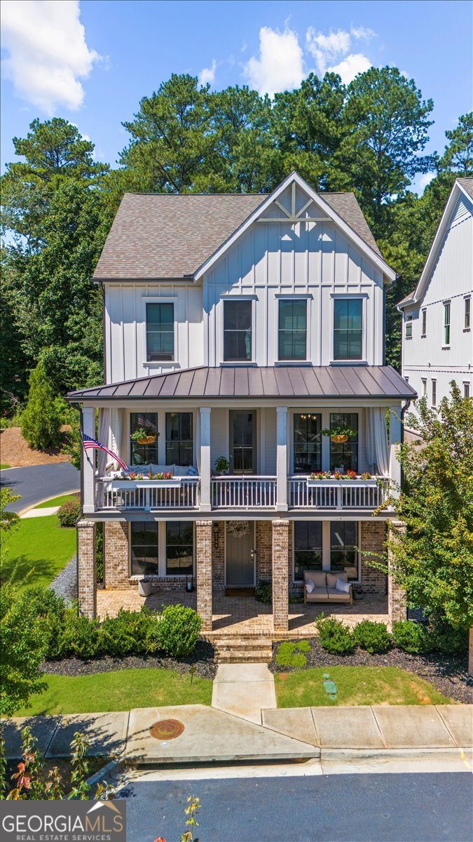 Originally the community model home, you will find upgrades throughout this EAST facing home. Elevator for easy access to all floors. 2 car garage has room for golf cart. You will love the proximity to schools, parks, and shopping (truly walkable!). Have a slow morning on the porch with your coffee or share a glass of wine on the back balcony or watch tv on the front balcony. The open concept living area is light-filled and perfect for entertaining or gathering with family. The spacious kitchen has upgraded Cafe appliances, large quartz island, double ovens, and pantry to please any cook. Upper floor has three ensuite bedrooms, so everyone has his or her privacy. A fourth ensuite bedroom is on the main level (currently serving as an office), and the fifth bedroom is on the ground floor with a separate bath detached. Designer touches throughout provide visual interest while maintaining serenity. Convenient yet private, bright and interesting, open for entertaining but with places to curl up and relax. Come see your next home! PROFESSIONAL PHOTOS COMING 8/26.