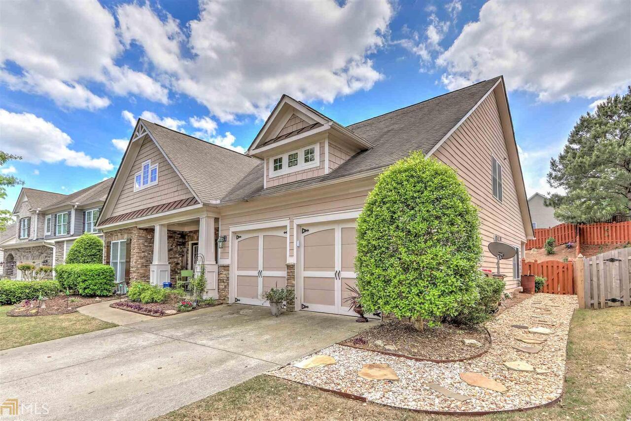 BACK ON MARKET- (Buyer's financing fell through) DO WHAT YOU LOVE, LIVE WHERE YOU LOVE DOING IT. The well appointed kitchen opens to the living room making this home perfect for ENTERTAINING. The CULINARY ARTIST of the home will find serving meals a breeze with the oversized island/breakfast bar. RETREAT to the spacious owner's bedroom located on the main floor with private bath featuring a soaking tub- perfect for RELAXATION. Offer guests their own space in the additional bedroom and full bath on the main level. Two bedrooms and a full bath are on the second level. CUSTOMIZE the additional room upstairs to fit the needs of work, school, or a playspace! ENJOY the privacy of the fully fenced backyard and UNWIND on the covered patio after a long busy day. Sterling on the Lake is a Lifestyle Community offering award winning amenities and convenient to the Mall of GA.