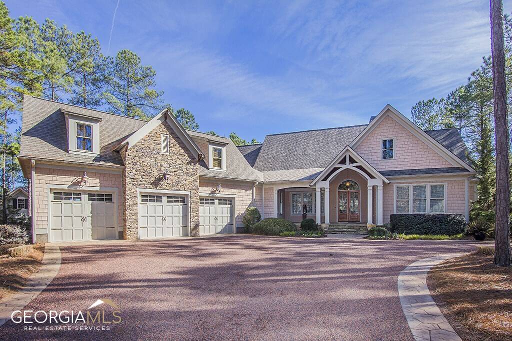 GREAT ONE FLOOR OPEN SPACE LIVING IN REYNOLDS LAKE OCONEE.  THIS LOVELY HOME HAS EVERYTHING YOU NEED WITH VIEWS AND PRIVACY. GREAT TRIM DETAIL, UNIQUE FINISHES, LARGE OPEN AREAS AND GREAT MASTER SUITE WITH SITTING AREA  AND FP, UPSCALE BATH AND HUGE FINISHED MASTER CLOSET. LARGE IN LAW SUITE OR HOBBY ROOM OVER 3 CAR GARAGE. KITCHEN DECKED OUT WITH HIGH LEVEL APPLIANCES AND CABINETRY, LARGE COUNTER AREAS WITH SEATING, AND LARGE EATING AREA. GREAT WINDOWS AND SLIDING DOORS BRING IN THE OUTDOORS BUT OFFER GREAT PRIVACY. LARGE SCREENED PORCH WITH OUTDOOR KITCHEN AND TREX DECKING. CUSTOM WINE ROOM.  ENJOY THE OUTDOOR SPACE WITH LARGE POOL W/RETRACTABLE COVER, PATIO AND HOT TUB. A SPECTACULAR HOME THAT MUST BE SEEN TO APPRECIATE ITS QUALITY. GOLF MEMBERSHIP AVAILABLE.