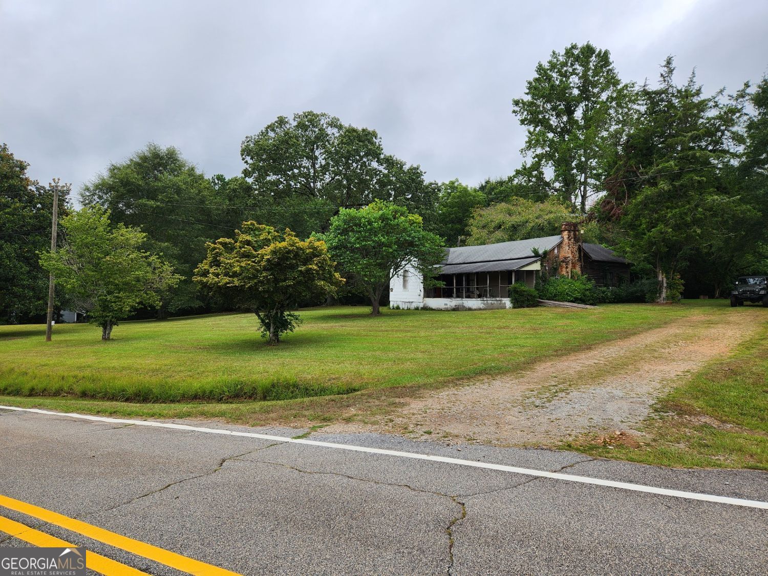 Want to get away? Gorgeous property with unlimited opportunities. 11.88 acres of an old family homestead. Full flowing stream running year-round with no documented flood plan. Water and electric are currently located at the house. Only 10 minutes to shopping and 18 min to the center of Carrollton; yet, with a very country feel.