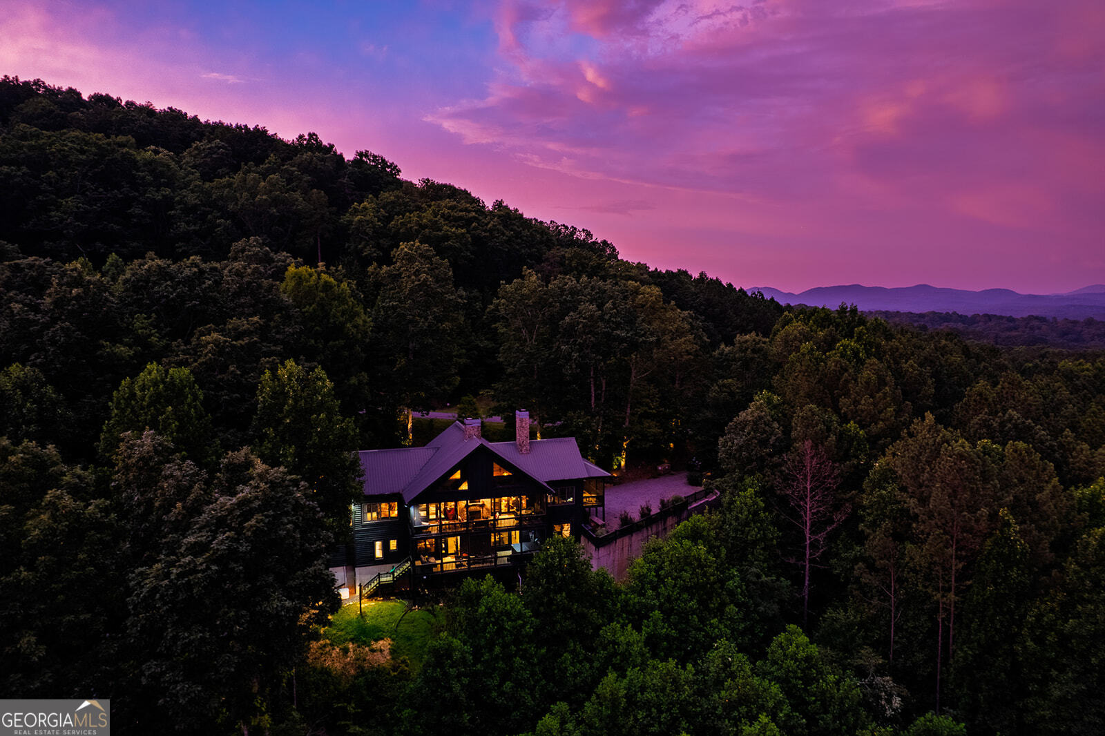 This remarkable mountain lodge with almost 4800 SF isn't just a retreat-it's a revenue-generating powerhouse. With over $100,000 in confirmed 2025 bookings, it's a turnkey short-term rental investment ready to deliver immediate returns. From the moment guests arrive, they're welcomed by brand-new retaining walls, steps, and a walkway that leads to an inviting firepit gathering area. A whole-house generator ensures seamless stays year-round-a feature rental guests love. Inside, with soaring ceilings the expansive living and dining area is built for entertaining, anchored by a dramatic stacked-stone wood-burning fireplace. On the opposite side, guests can relax in a TV lounge while enjoying breathtaking mountain views. French doors open to a sprawling screened porch with yet another wood-burning fireplace, creating the ultimate four-season experience. The main level features two primary suites, each with private screened porches and en suite baths-perfect for couples or multiple families. The gourmet kitchen, complete with granite countertops, double ovens, gas cooktop, and laundry, is designed to handle group stays with ease. Upstairs, the loft with a private bath adds even more flexible sleeping space.The terrace level is an entertainment hub that keeps guests coming back year after year. It boasts a massive bonus room with Foosball, Pac-Man arcade, wet bar with fridge, and an 85" TV. From there, step out onto another screened porch with a hot tub and bed swing-two must-have features for STR success. A dedicated pool table room with bath and closet doubles as an extra bedroom, while the opposite wing offers two additional bedrooms joined by a Jack-and-Jill bath. Other income-boosting features include a dog-wash room with exterior access (pet-friendly rentals command premium rates) and two extra rooms that can serve as bedrooms or flex spaces, maximizing guest capacity. This property is offered fully furnished (with minimal exclusions), making it 100% turnkey. Between its proven rental history, expansive amenities, and strong future bookings, this lodge is not only a spectacular mountain escape but also a rare high-performing short-term rental investment. The owner and friends can use the cabin at their leisure whenever they want! It's the best of both worlds.