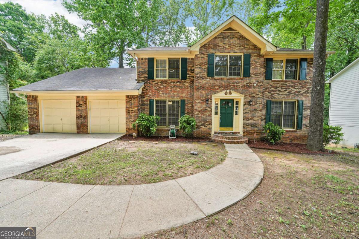 Welcome to this brick-front beauty, set on a sweeping, tree-lined lawn in sought-after Hidden Hills! Step inside the welcoming foyer to find light-filled formal spaces: a dining room with classic chair rail and a flexible living room or home office. Rich hardwoods lead to the heart of the home-a sun-splashed living room with brick fireplace and custom built-ins, seamlessly connected to a show-stopping kitchen with wood-look tile, granite counters, stainless appliances, soft-close cabinetry, built-in desk, and a bay-window breakfast nook overlooking the backyard. Upstairs, retreat to the generous primary suite with dual vanities, a tiled tub/shower combo, walk-in closet, and bonus room-perfect for a nursery, fitness area, or private retreat. Three additional bedrooms share an updated hall bath. The daylight terrace level expands your living space with a large rec/media room, two bedrooms, and a newly renovated full bath-ideal for guests or multi-generational living. Outdoor living shines on the expansive deck with views of a landscaped yard, mature trees, and storage shed. Hidden Hills is on the rise, with county-approved plans to restore the historic golf course adding future value and community appeal. All this, less than 10 minutes to I-285, shopping, dining, and Stone Mountain Park trails. With no HOA and strong rental potential, this turnkey home is a rare find. Schedule your private tour today!