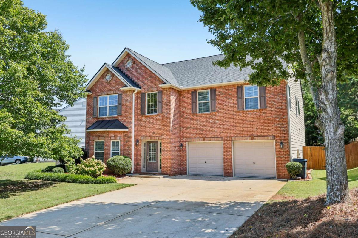 Don't miss this beautifully maintained, move-in ready home nestled in the sought-after Autumn Cove community! This spacious residence offers 5 bedrooms, including an oversized primary suite featuring a luxurious en-suite bath with double vanity, jetted soaking tub, separate shower, and a custom walk-in closet system. The heart of the home is the expansive chef's kitchen with granite countertops, a large island, and breakfast bar seating, perfect for entertaining or casual family meals. The open concept layout flows seamlessly into the separate dining room and cozy family room with a gas fireplace, creating a warm and inviting atmosphere. Step outside to your private, fenced backyard oasis, complete with a patio, lush green lawn, and beautifully landscaped surroundings. Ideal for relaxing or hosting friends and family. The main floor HVAC is less than a year old, and the roof is only two years old, offering peace of mind for years to come. Residents of Autumn Cove enjoy access to a community pool with a grilling area and love the convenience of being close to Publix, Kroger, Costco, restaurants, shopping, entertainment and 400. This home truly has it all! Space, style, updates, and location. Schedule your tour today and make this stunning property your forever home!