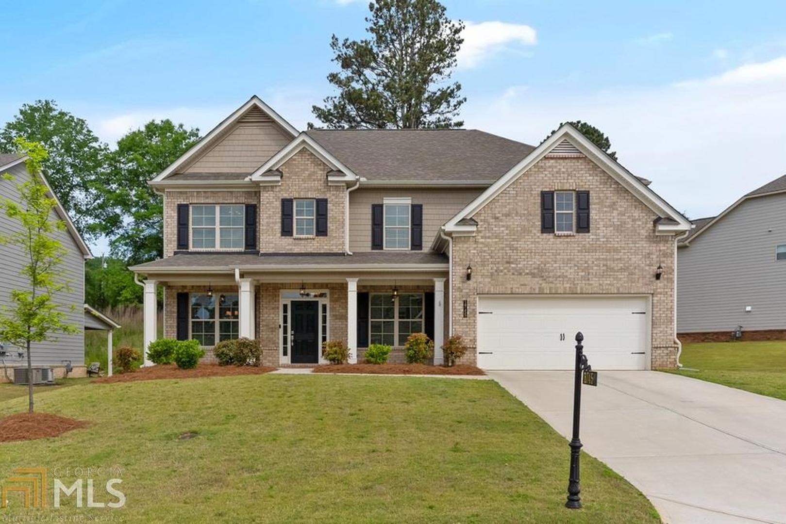 NEARLY NEW HIGHLY UPGRADED 5 BEDROOM HOME ON LEVEL LOT IN NEW SWIM COMMUNITY, WEST FORSYTH! Honestly, the most pristine, model perfect home I've seen! White Kitchen with Custom cabinet vent hood, deep stainless sink, white granite counters, stainless appliances including double ovens, and walk in pantry. Family room has custom bookcases and stone fire surround. Guest suite on main. Dining room with coffered ceiling. French doors lead to office on main. Master bedroom up with 3 secondary bedrooms plus Loft! The perfect floor plan. Covered patio overlooks private backyard. Great location and schools. Swim community. Perfect!