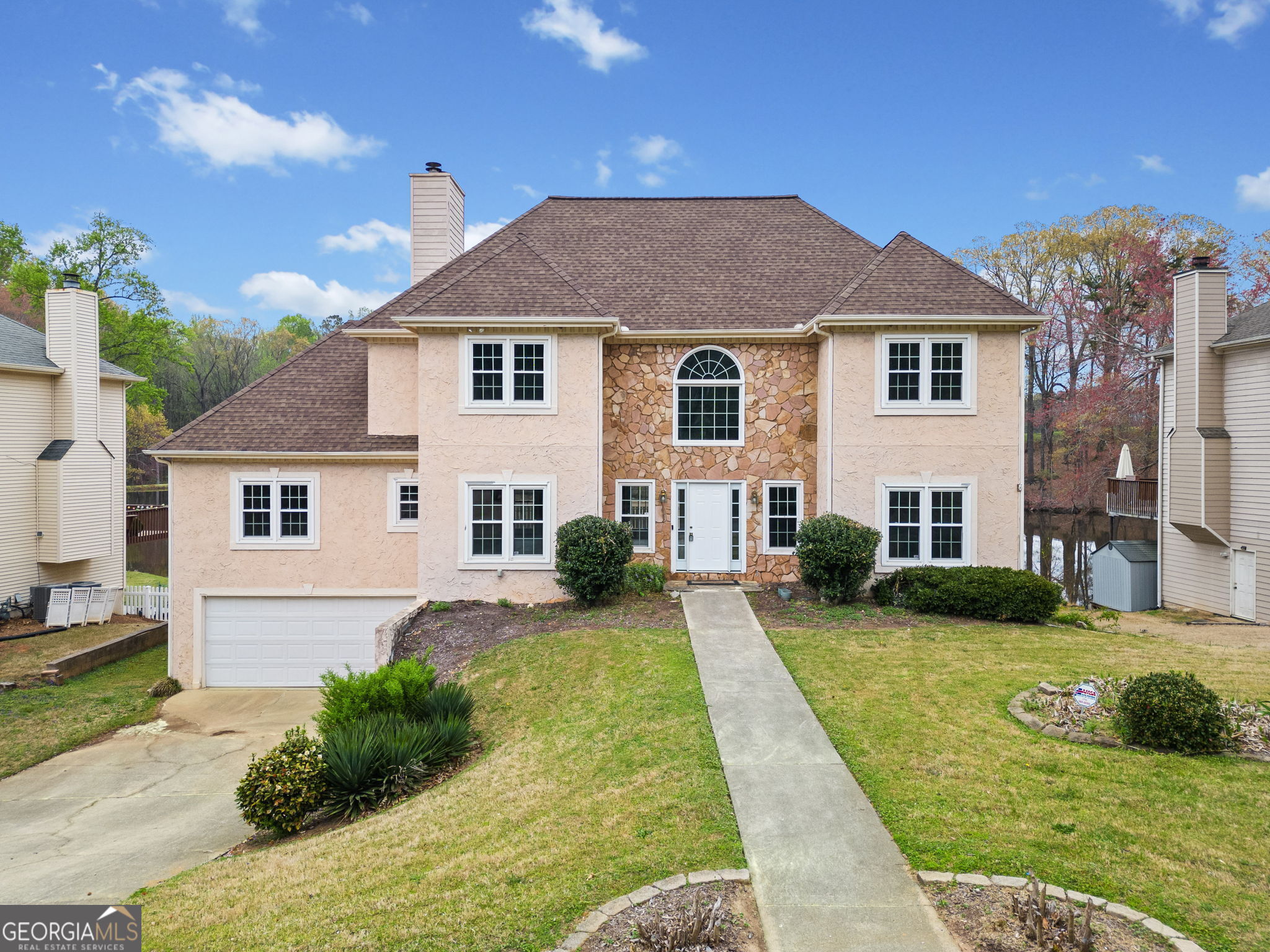 **Stunning Lakefront Property with Spacious Deck and Exceptional Features Offering a lot of Potential** Welcome to this beautiful stunning lakefront home in East Cobb offering a lot of potential for customization and long-term value. Priced with updates in mind, featuring a large back deck that overlooks the serene community lake-a perfect spot for relaxing or entertaining. The spacious foyer leads to a grand two-story living room with lots of windows that fill the room with natural light, complemented by a built-in bookcase for added charm. You'll love the kitchen with white cabinetry, tiled backsplash, stainless steel appliances including new fridge in 2022, abundant counter space, and a cozy breakfast nook for casual dining. The main-level master suite is a true retreat, offering a vaulted ceiling, a large walk-in closet, and a cozy gas fireplace. The ensuite bath features two vanities, a soaking tub, and a large separate shower. Upstairs, you'll find two well-sized bedrooms with a shared bath, plus an additional bedroom with its own private ensuite. The walkout basement is unfinished with a large terrace that opens to the lake-perfect for fishing, setting up a firepit, and creating a seating area to enjoy the peaceful views. The basement also includes a finished bedroom and bath, as well as a versatile flex space ready for you to customize to fit your needs. HVAC replaced in 2022. Water heater recently replaced January 2025, freshly painted interior and exterior March 2025. Seller is Motivated therefore bring your offers and we will respond back to you within 24 hours. Don't miss your chance to make this beautiful lakefront home your own!