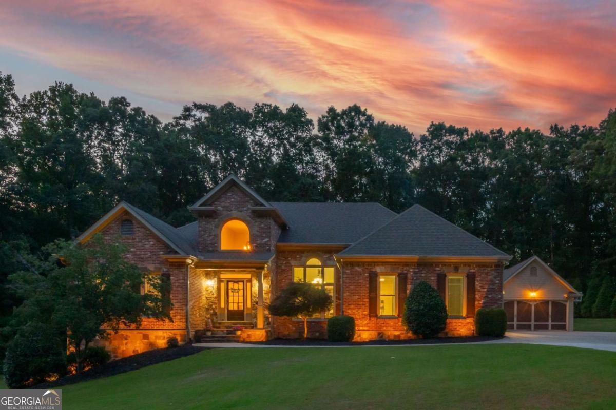 Welcome to 644 Herring Road, where life feels more like a private retreat than a suburban routine. Set on a private 3.15, unrestricted acres just 2 miles from downtown Grayson and only 6 miles from the heart of Lawrenceville in the popular Grayson high school district, this four-side brick estate offers the space, freedom, and flexibility today's homeowner craves, with no HOA to limit what you can do. Whether you're an avid entertainer, a car enthusiast, or a small business owner with work vehicles or tools that need a home base, the detached garage and expansive grounds give you the freedom to create, build, store, or unwind on your own terms. Imagine mornings spent sipping coffee beneath coffered ceilings on the covered patio overlooking the amazing backyard, afternoons grilling under the cabana by the saltwater pool, relaxing with a beverage by the firepit over conversation with friends, or unwinding in your private theater as the day winds down. With four bedrooms spread across two levels, including a main-level primary suite with poolside access, there's space for guests, in-laws, or teens to have privacy without being far. There's also a big bonus room above the garage, and another big one in the basement. And with three major parks, multiple youth sports leagues, fishing lakes, and biking trails within a 10-minute drive, you're never far from fun, yet always just far enough away to feel at peace. I-85 is a few miles away for easy commuting, and the nearby amenities in surrounding cities and counties offer everything from date night dining to daily errands without the long drive. More than a house, this is a lifestyle, where weekend projects, outdoor memories, and quiet luxury come together in one unforgettable address.