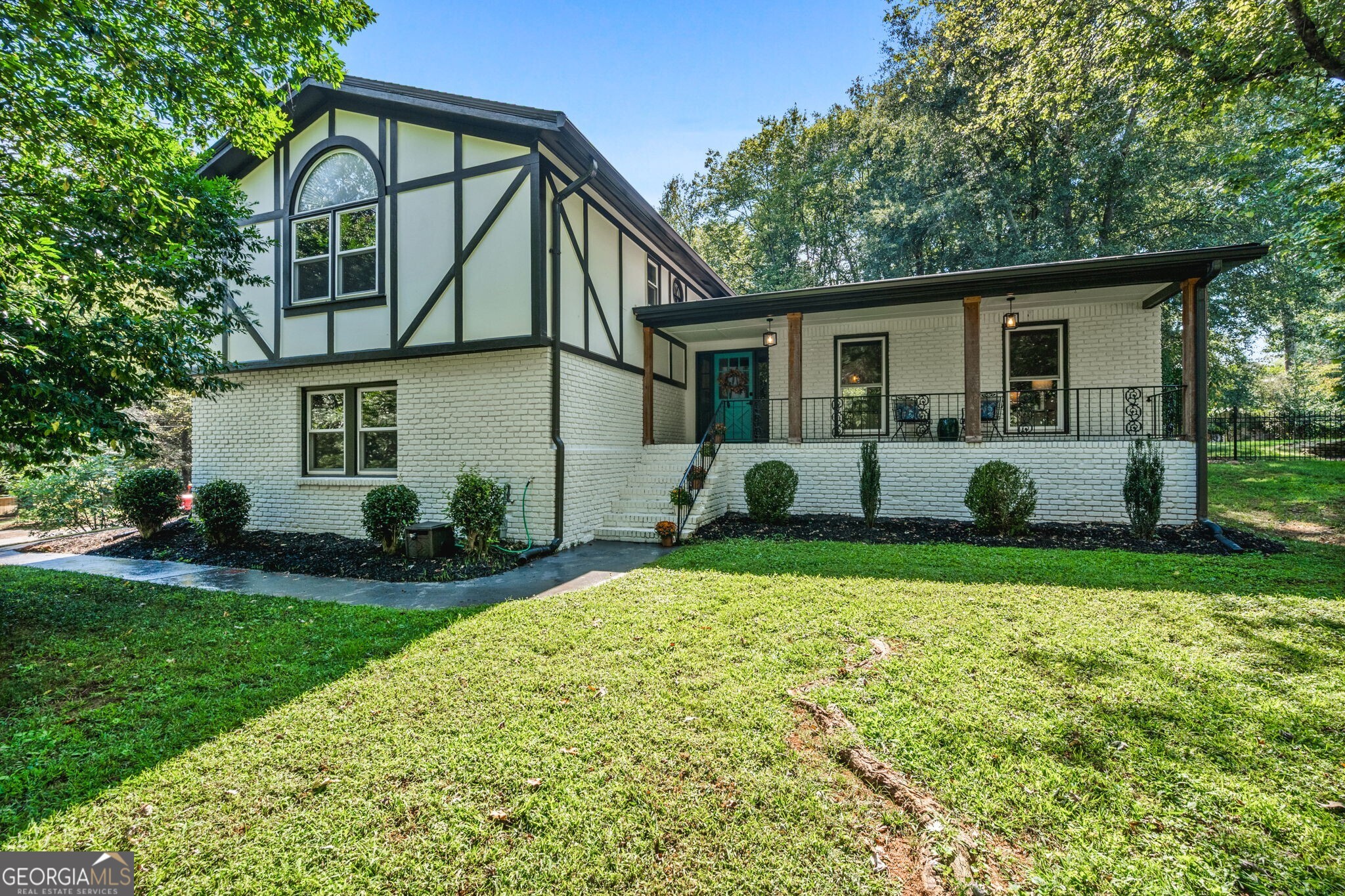 Welcome to 375 Jade Cove Drive! A traditional Split-Level home with Tudor-style flare, this home is right down the road from all your favorite Downtown Roswell spots. The home is set on a large corner lot with an inviting front porch. Every feature is updated top to bottom, starting with your open living, dining and kitchen, perfect for entertaining. The large island features plenty of seating in addition to room for a full size dining table. Hardwoods throughout will carry you to the secondary living space on the bottom floor adorned with a cozy fireplace in-between built-in shelves. Down here you will also have an ample sized mudroom/laundry room that is your entry from the two car garage. Finishing off this level is a half bath. One full level up from this are two secondary bedrooms, a full bathroom and a Primary Suite with another en-suite bathroom. The Primary bath has a separate shower and soaking tub, double vanity, and extra storage space all set in a large open footprint. On the other side of your Primary suite is a nook that divides your his-and-her closets. Making our way outside, you will find a fully fenced and perfectly flat half-acre lot. Standing on your patio, you will be facing an additional air-conditioned space that has electrical and ready for an office, studio or any number of hobbies! On the back side is additional storage/workspace. After enjoying your new home, make sure and wander up to Canton Street, just about 1 mile away, to enjoy the multitude of shopping and dining options - or just a bit further down the street to find fabulous outdoor trail and hiking experiences around the Mill. This home truly has everything you need and want. Welcome Home!!