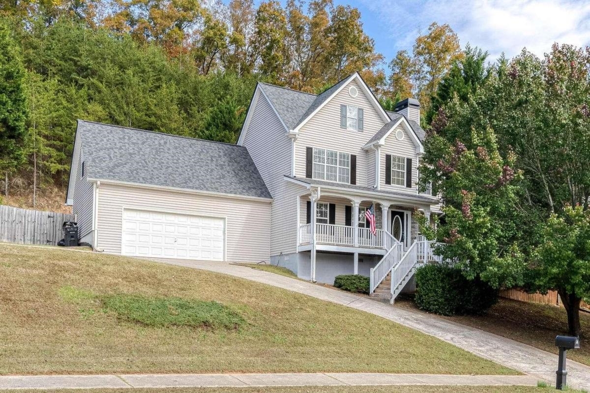 Beautiful home with great front porch. Updated kitchen with granite countertops and stainless steel appliances. Kitchen also features a wine and coffee bar. The downstairs has a spacious family room with stack stone fireplace and a separate dining room. There are 4 oversized bedrooms upstairs. Primary bedroom has trey ceilings and primary ensuite. Backyard is fenced with an large deck great for entertaining. The driveway has an extra parking pad. Home is located near downtown Canton and minutes from I-575 and near the lake.
