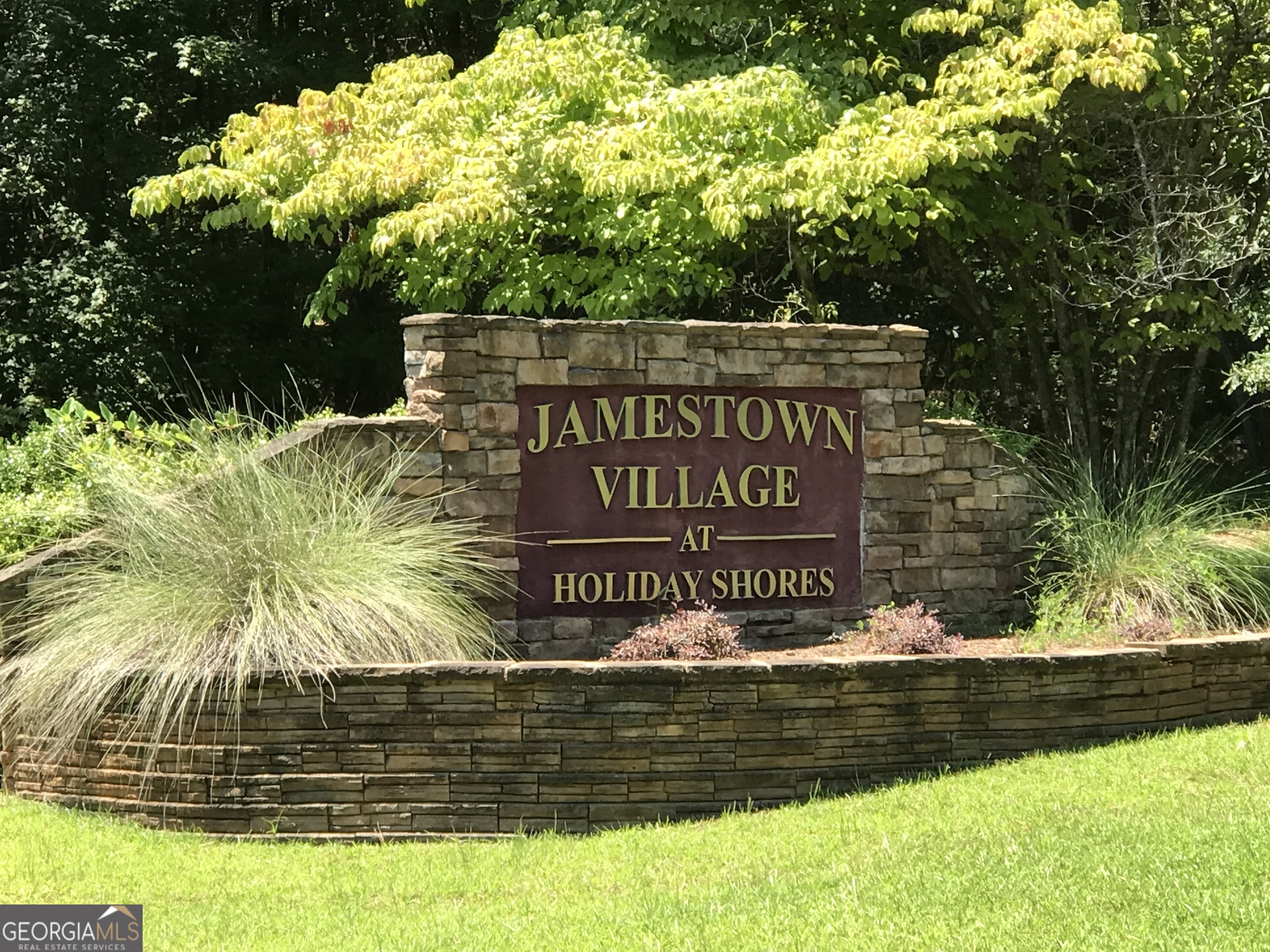 Welcome to Jamestown Village at Holiday Shores on Lake Sinclair!!! Beautiful wooded 1.02 acre interior lot with fabulous community amenities to include a community boat ramp, two community boat docks, two pavilion/picnic areas with grills and community restroom in gated amenities area. Lake Sinclair is a 15,300 acre lake with over 400 miles of scenic shoreline. It is known as one of the cleanest lakes in Georgia and if fishing is your thing, there are many species of favorites to include Largemouth bass, white bass, striped bass, catfish, crappie, hybrids, bream and more. Imagine living on Lake time without paying lakefront prices. This lot is located in Phase 1, so mobile homes, manufactured homes and modular homes are welcome but must be approved through the HOA. Community is not gated but the amenities area is gated. Lot 204 (1.02 acres) abuts up to this lot and is available for sale as well and can be purchased together with lot 203. There are pink ribbon markers located in front of the lot but Buyer will need to verify property lot lines. Fiber internet is now available thanks to the partnership between Washington EMC and Conexon Connect!! There is a helicopter landing pad next door in the Holiday Shores community for medical emergencies needing air transportation, and if you choose, you can subscribe to the AirEvac Lifetime Membership Program through AirMedCare Network 1-800-793-0010 to utilize their services for a yearly fee. There is also a volunteer fire department close by that services Jamestown Village and surrounding areas. The fish are biting!!! What are you waiting for!!!