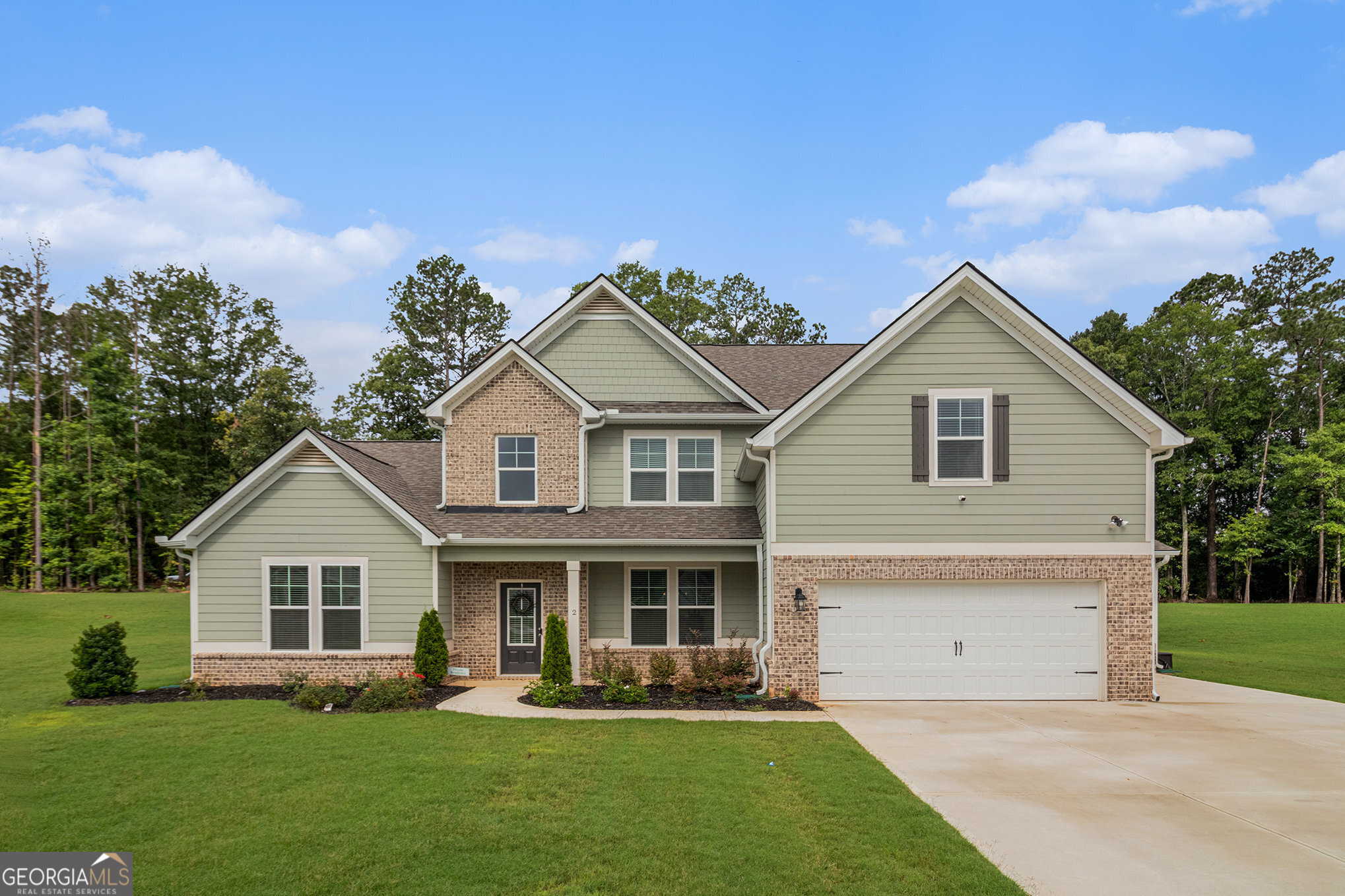 Welcome to the Henry II by DRB Homes, located in the desirable Mill Pond community! This stunning 5-bedroom, 3.5-bath home offers a spacious and thoughtfully designed layout, perfect for modern living. The main floor features a luxurious owner's suite with a spa-inspired en-suite bath, complete with tile flooring and a freestanding soaking tub for ultimate relaxation. Enjoy seamless flow throughout the main level with durable luxury vinyl plank flooring (bedroom excluded), a gourmet kitchen equipped with stainless steel appliances, a cooktop with microhood, double wall ovens, quartz island, and beautifully painted cabinetry. The inviting great room includes a cozy fireplace-ideal for gatherings or quiet evenings. Upstairs, you'll find a versatile media room perfect for movie nights, gaming, or a home office. Step outside to a covered back porch, great for entertaining or enjoying peaceful mornings, and take advantage of the convenience and storage offered by a spacious 3-car garage. Additional features include exterior floodlights for added security and charm. Don't miss the opportunity to own this exceptional home that blends luxury, comfort, and style!