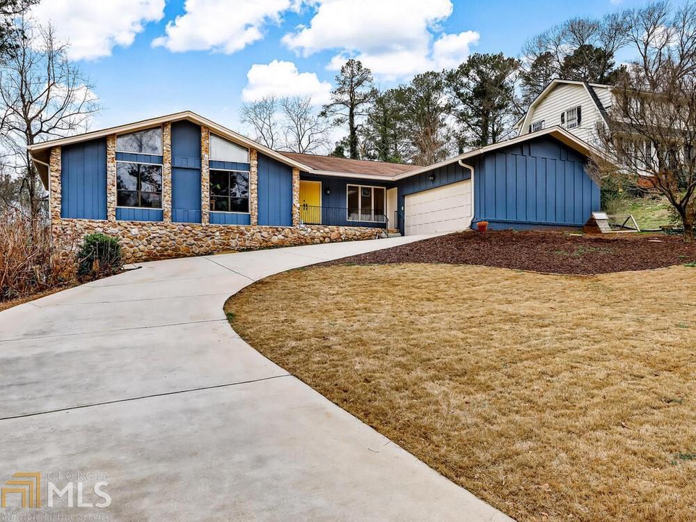 This home sits proudly on it's nearly half acre lot. It's charming Mid-Century Modern inspired architecture features ranch style living with a FULL unfinished walk-out basement. All 4 bedrooms, including the Owner’s Suite, are located on the main floor along with the additional Hall Bath. The entire home is light and bright - The front living room is open and airy - perfect for entertaining. There is a separate Dining Room with access to a side patio. The Eat-In-Kitchen leads out to the private back yard and back deck. The Family Room has a gorgeous floor to ceiling brick fireplace - perfect for chilly nights! Other features include. Large 2-car attached garage, fresh paint, newly installed beautiful luxury vinyl floors . It’s a perfect house on a perfect street in The East Riverbend neighborhood of Lilburn.