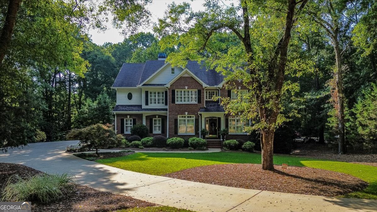 1011 Magnolia Drive - Bespoke luxury in Prestigious Lake Welbrook. 6Beds - 4Baths ~ 4800sqft - 1.69 Acre Estate built in 1998. Tucked along the lush tree-lined lanes of exclusive Magnolia Drive, this stately all-brick estate commands attention. A sweeping circular driveway and elegant portico deliver sophisticated curb appeal befitting its refined neighborhood with an Athens address in Oconee County! Greeted by a Grand Formal Dining Room & Study cultivate the excitement builds in these polished, purpose-built rooms. The informal living room connected to the kitchen is a central gathering place anchored by a cozy fireplace and bathed in natural light -- ideal for both lively occasions and intimate evenings. The well appointed kitchen equipped with modern appliances including built-in range, dishwasher, fridge and more, complemented by expansive counter space and breakfast area. The seamless flow of this home toward family areas and covered back porch makes indoor-outdoor entertaining effortless. Upstairs is the Luxurious Master Suite haven featuring an updated spa-inspired bath and generous closet space. Also there are three well appointed guest bedrooms and one additional bath ensure comfort and privacy for all. The lower level has 2 additional bedrooms, a full kitchen and a full bath finished out superbly for in-laws extended guests or rental opportunity. It offers many handicap accessible upgrades. Part of the prestigious Lake Welbrook community, residents enjoy quiet privacy just minutes from Athens vibrant cultural scene and the University of Georgia. Top-tier schools, boutique shopping, gourmet dining and recreational amenities are all well within easy reach.