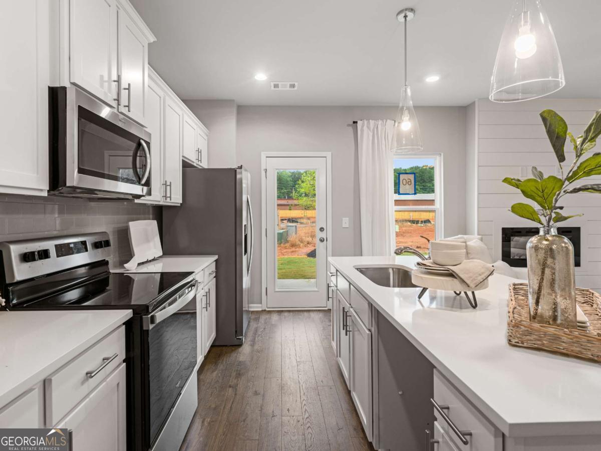 Only 1 Unit Remaining! Enjoy limited-time builder incentives at Caldwell Park-a beautifully crafted townhome community in a park-like setting on Cobb County's growing South Side. Nestled in Mableton, this 90-unit neighborhood features green spaces, ponds, dog parks, and a fire pit pavilion. Conveniently located near I-20, I-285, and Veterans Memorial Hwy, you're just 15 miles from downtown Atlanta, 10 miles from Smyrna-Vining's, and minutes from Sweetwater Creek State Park and Six Flags.