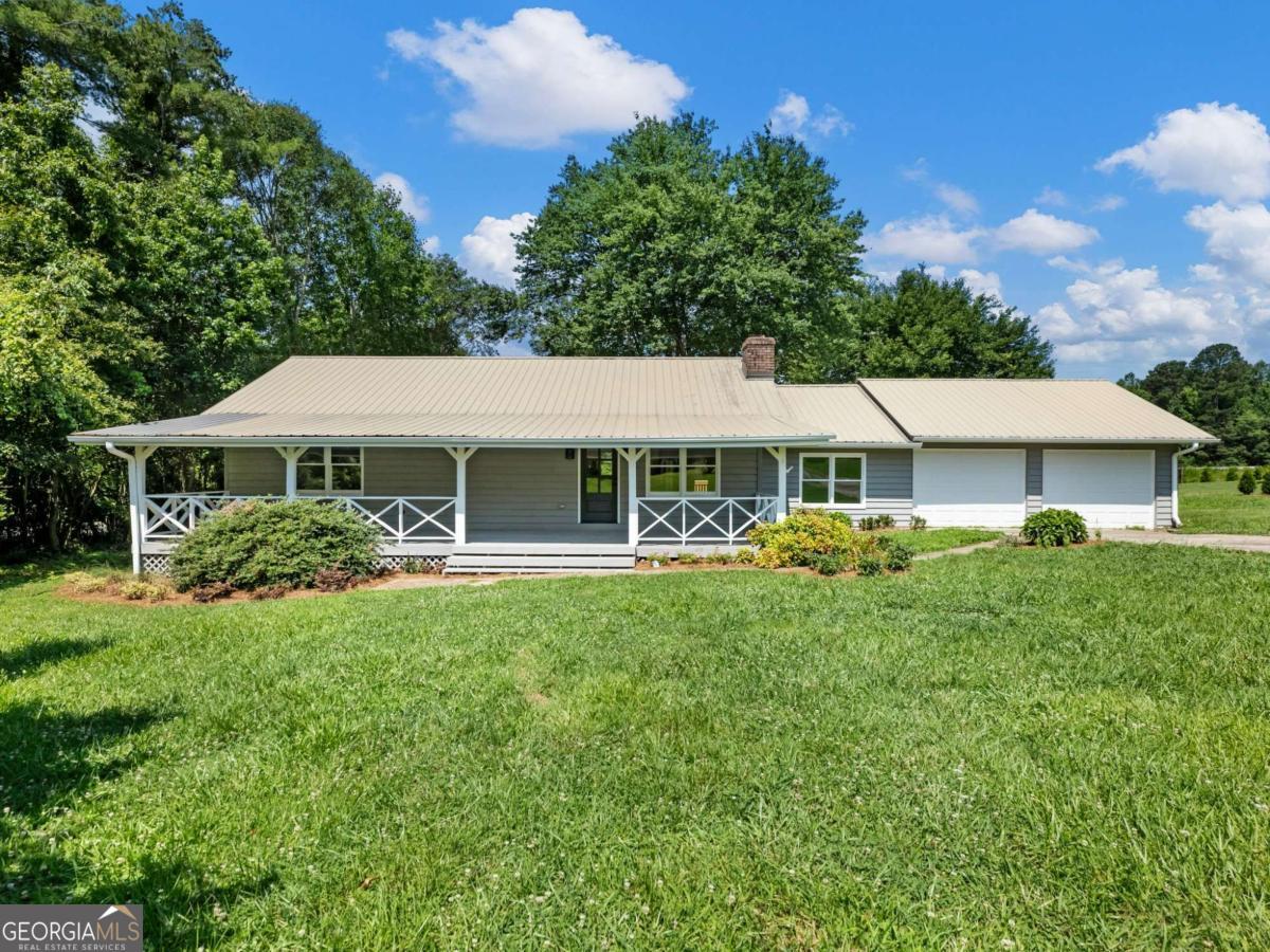 Location, Location, Location! This beautifully remodeled ranch home in the heart of Clermont, GA is an absolute showstopper. With a well-designed layout and thoughtful updates throughout, this home offers the charm of an established neighborhood with the benefits of modern upgrades. Inside, you'll find spacious bedrooms and an open floor plan that flows effortlessly-perfect for everyday living or entertaining. The home is less than a mile from downtown Clermont, providing easy access to shops and restaurants in Clermont, Cleveland, and Gainesville while still offering a peaceful, country feel. A second driveway leads to a covered parking area and an additional detached garage-ideal for a workshop, boat storage, or extra space for hobbies. Enjoy quiet mornings on the welcoming front porch and host gatherings on the large back deck with room for friends and family.