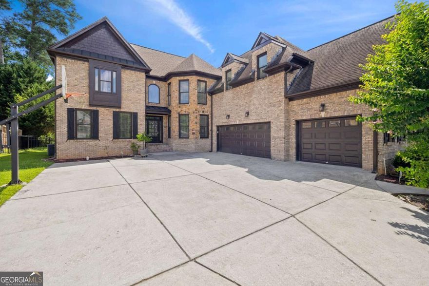 Don't miss this exceptional home in one of Suwanee's most desirable communities! Located within the award-winning North Gwinnett School District, this stately four-sided brick home offers an unbeatable combination of location, space, and quality. Being close to downtown Suwanee, you'll enjoy easy access to local parks, restaurants, walking trails, and family-friendly events throughout the year.  Set on a beautifully landscaped lot, the home features a side-entry three-car garage that enhances both curb appeal and functionality. Inside, you'll find refinished hardwood floors, elegant trim work, and a flowing floor plan designed for both comfort and style. The gourmet kitchen is equipped with top-of-the-line stainless steel appliances and opens to a vaulted keeping room with a cozy fireplace, perfect for everyday living or entertaining.  The impressive two-story great room features a second fireplace, built-in shelving, and overlooks the fenced, professionally landscaped backyard-an ideal space for gatherings or play. A main-level office or study provides a quiet, private work-from-home area.  Upstairs, oversized bedrooms each have access to a private full bathroom, offering both luxury and privacy.  The finished terrace level adds incredible flexibility with two additional bedrooms, a full bath, and multiple entertainment areas-perfect for movie nights, a game room, or extended guest stays.  From top-rated schools and thoughtful design to its unbeatable location near everything Suwanee has to offer, this home truly has it all.