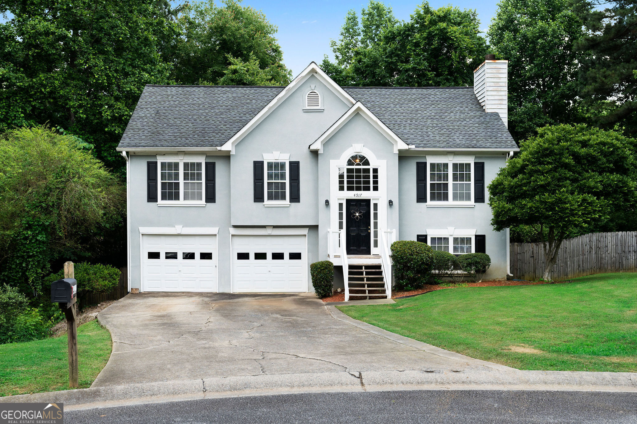 Hurry to see this inviting cul-de-sac home with 4 bedrooms and 3 full baths. Offered As-Is for you to make this home your own, this split-level gem is nestled in a tranquil neighborhood, offering the perfect blend of modern comfort and classic charm. As you step inside, the main level welcomes you with a spacious living area and cozy fireplace. The living area flows seamlessly into the dining area and spacious kitchen, featuring warm wood cabinets, a breakfast bar, tiled floors, stainless steel appliances (including a gas range), and a pantry. Double doors from the dining room lead to a three-level rear deck that overlooks the fenced-in backyard, creating a private haven perfect for kids, pets, and outdoor activities. On the main level, you'll find three generously sized bedrooms. The primary suite includes a spacious primary bath with a separate shower and soaking tub. The terrace level boasts an additional bedroom and a full bath, ideal for guests, teens, or in-laws. This level also includes a bonus room that can serve as a den, media room, game room, or office. The two-car garage features an extra-long side, perfect for trucks, boats, or four-wheelers. Location is key: this home is minutes from Lake Allatoona, Lake Acworth, I-75, historic downtown Acworth, Town Center Mall, KSU, and Kennesaw Mountain. Bring All Offers for this home with 2-year young carpeting & HVAC replaced 2022/transferrable warranty. Ask how you can receive up to $1500 credit by using one of our preferred lenders. Exclusions may apply.
