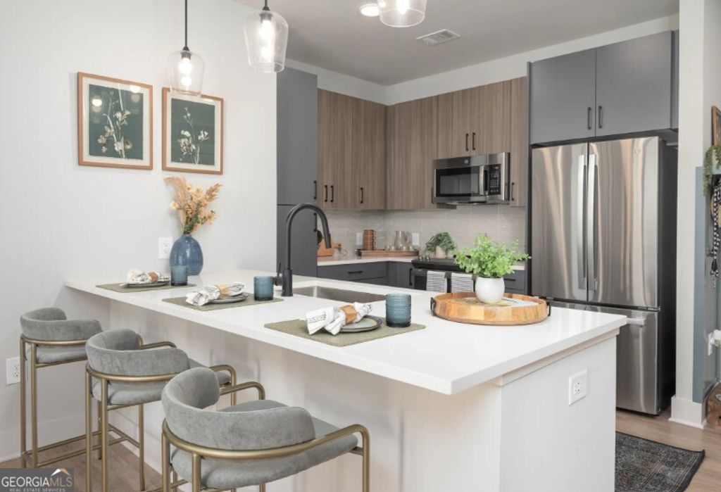 Photo of 1400 Laurel Crossing Parkway #1413, Buford, GA 30519 (MLS # 10655517)