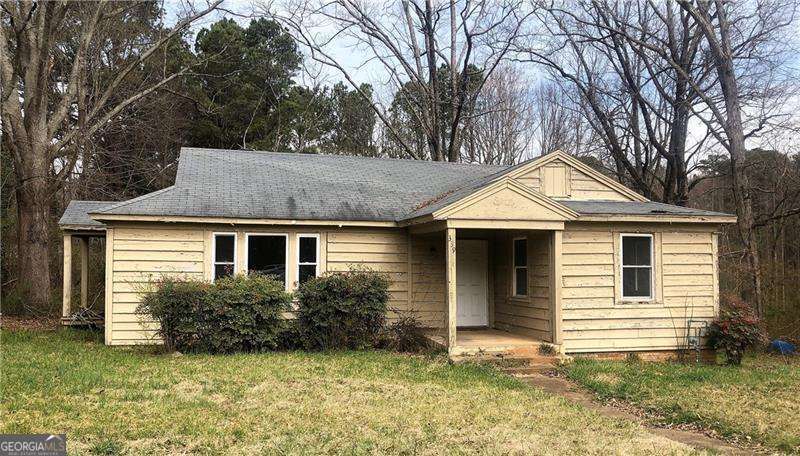 **Incredible Opportunity!** Unlock the potential of this charming fixer-upper bungalow or consider a complete rebuild to suit your vision. This property includes a massive barn/storage building, perfect for various uses. Nestled on 1.28 acres with 125 feet of prime road frontage, it offers unparalleled convenience, being less than a mile from the FOCO Courthouse and within the Cumming city limits. Additionally, this property holds potential for commercial development, making it an even more attractive endeavor. Don't miss out on this rare chance to create your dream property in a highly desirable location!