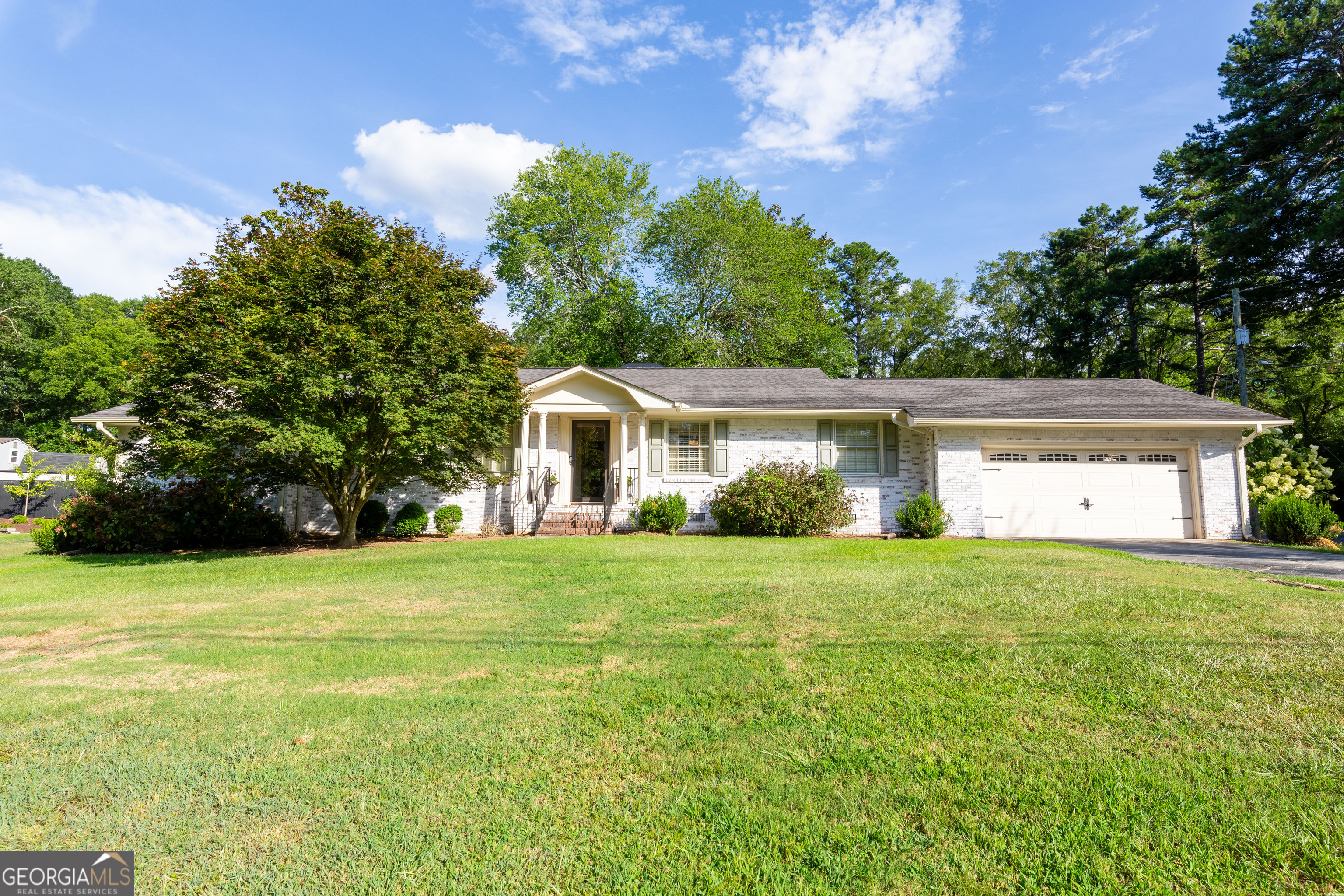 Fall in love with this beautifully updated 3-bedroom, 3-bath home located just steps from the heart of Downtown Monroe and Childers Park. NEW ROOF to be installed on 8/2 with an assumable warranty for the new homeowner-offering added peace of mind and long-term value. Whether you're headed to a local festival, dining at your favorite cafe, or enjoying a relaxing walk, you'll appreciate everything this golf cart-friendly community has to offer. Inside, you'll find gleaming hardwood floors throughout, a versatile bonus space perfect for a home office or playroom, and stylishly upgraded bathrooms featuring granite countertops. The open and airy layout offers modern touches and a cozy feel that's perfect for both everyday living and entertaining. Enjoy peaceful mornings on the screened-in porch or host friends and family in the spacious backyard-complete with a 12x16 shed that stays with the home! A double car garage adds extra storage and convenience. Located in the highly sought-after Walnut Grove School District, known for some of Monroe's best schools, this move-in ready gem offers the perfect blend of charm, function, and location. Don't miss this rare opportunity to own a beautifully updated home with small-town charm and big-time convenience.