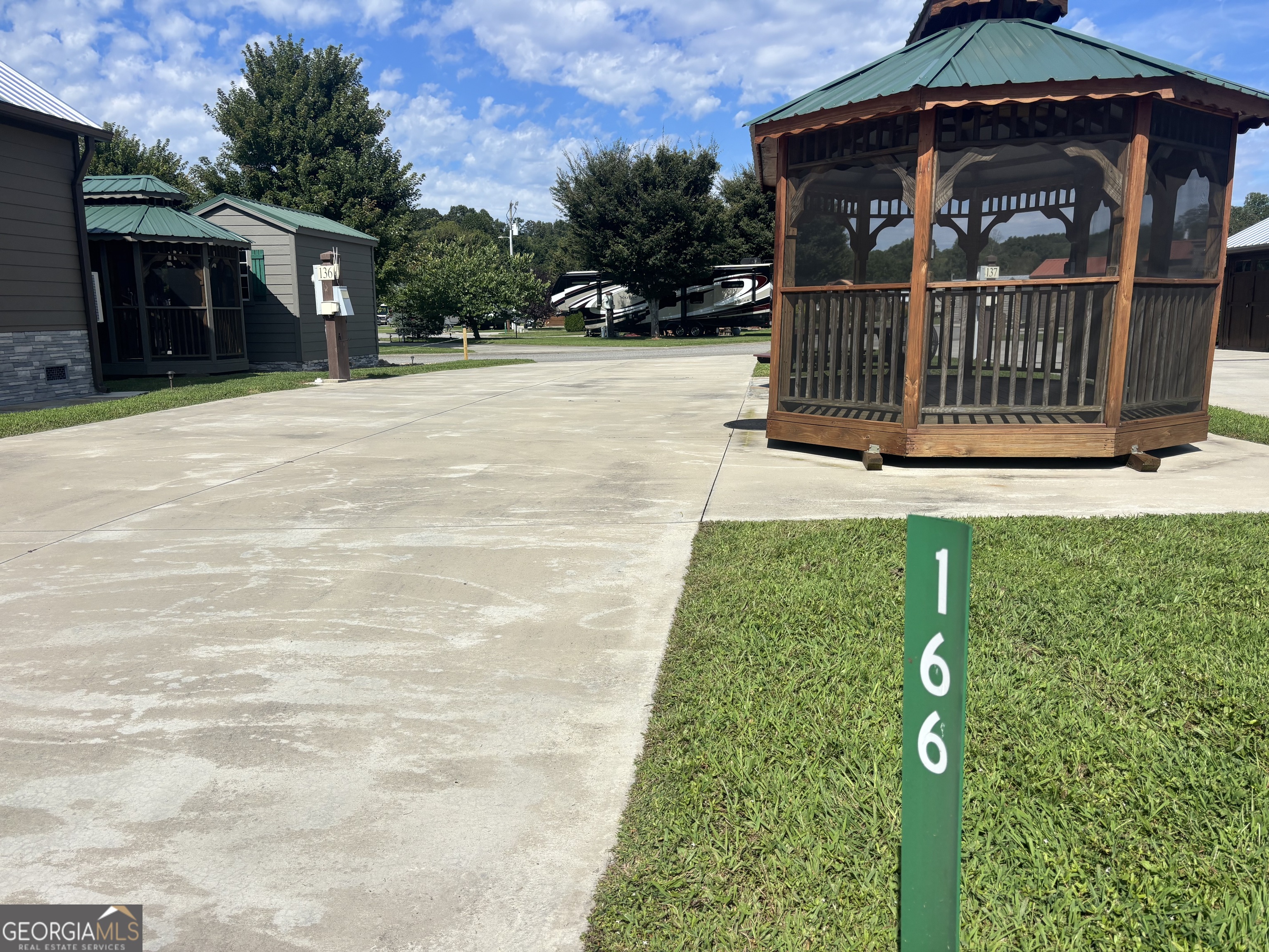Discover your perfect getaway in this charming RV community! This well-appointed lot features a beautifully designed rock pad, inviting guests to enjoy al fresco dining or relax under the stars at the picnic table, thoughtfully positioned for optimal outdoor views and endless activities. The highlight of this lot is the lovely gazebo, complete with screens to shield you from the elements, allowing you to savor the beauty of nature in comfort. Whether hosting friends or enjoying a peaceful retreat, this space is ideal for creating lasting memories. Embrace the RV lifestyle and the sense of community in this inviting environment! This pull-through lot is perfect for those seeking easy parking for a fifth-wheel or the largest motor coach. Nestled within 100 acres of stunning landscapes, the vibrant community offers a perfect blend of comfort and recreation, with convenient access to all amenities. This exceptional property grants you access to a wide array of amenities designed for leisure and enjoyment. Your monthly HOA fee includes access to a sparkling pool, an inviting hot tub, and a luxurious spa featuring a massage room to unwind after a long day. Stay fit in the state-of-the-art fitness center or challenge friends to a game of pool or darts in the entertainment area. For pet lovers, a dedicated dog park provides a safe space for your furry friends to play and socialize. Additional conveniences include a bathhouse and laundry facility, ensuring all your needs are met within this welcoming community. Experience the perfect blend of relaxation and recreation in this extraordinary setting, where every day feels like a getaway!