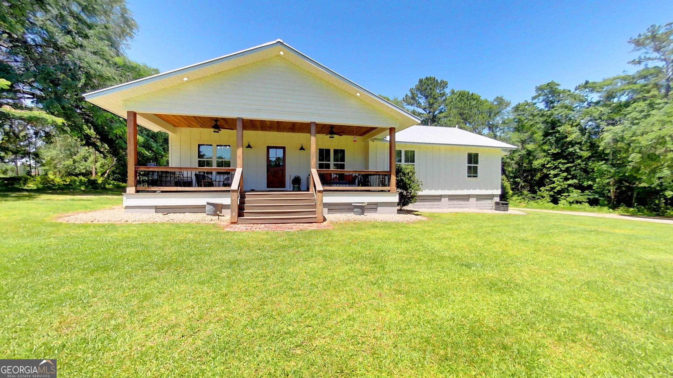 Experience country living at its finest in this beautifully renovated historic home, originally located in Thomasville, Georgia, now situated on approximately 2.75+- acres. Meticulously moved and remodeled, this residence features a stunning master bathroom addition and offers a perfect blend of charm and modern comfort. Enjoy the tranquility and privacy of this quiet estate, complete with a spacious covered front porch overlooking an expansive, well-maintained yard-horses are welcome! The property includes ample garden space and lush landscaping. Inside, the open-concept kitchen and living area are filled with natural light and feature high wood ceilings, creating an airy and inviting atmosphere. The kitchen boasts a large bar, pantry, hard surface countertops, double ovens, a gas stove with downdraft, and a wine cooler-perfect for entertaining. The private primary suite offers a serene retreat with wood ceilings, a luxurious bathroom with double vanities, a tile shower, a soaking tub, and a large walk-in closet. There are three additional bedrooms with original wood floors and a charming full bath with a stand-up shower and wood ceilings. This home combines historic charm with modern updates, making it a perfect country sanctuary. Home is centrally located between Tallahassee Florida and Thomasville Ga and a quick drive into either.