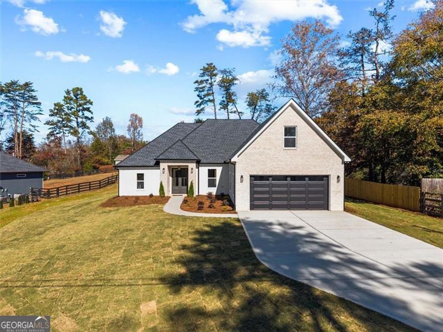 This brand new 2025 custom-built home is calling your name-ring, ring, ring! That's the sound your phone should be making to schedule your showing or make an offer. Perfectly situated in a highly sought-after neighborhood surrounded by beautifully maintained, million-dollar homes, this property delivers modern comfort and timeless style.  Inside, you'll find 4 spacious bedrooms and 3 full bathrooms, plus a convenient mudroom just off the garage. Soaring 10' ceilings in the foyer, 9' in the dining area, and 12' in the living room create an open, airy feel. LVP flooring runs throughout (because who really wants carpet?), with sleek tile finishes in the bathrooms and laundry room-yes, a real laundry space, not a cramped corner.  The chef's kitchen features quartz countertops, a pot filler for easy cooking, shaker-style soft-close cabinets, a wine fridge, and all appliances included. The living room boasts a floating electric fireplace for that perfect modern touch, while the exterior pairs brick and Hardie panel siding with architectural shingles-a look that stands out and lasts.  Enjoy your flat front and backyard, perfect for gatherings, outdoor games, or your creative landscaping ideas. The covered porch is already wired for a TV, setting the scene for game days and summer cookouts.  The split-bedroom floor plan provides privacy for the primary suite, and with no HOA, you'll have the freedom to truly make this home yours-no rental restrictions, no rigid rules, just ownership your way.  Got a boat or love the water? You're in luck-the public neighborhood dock and park are just a short walk away.