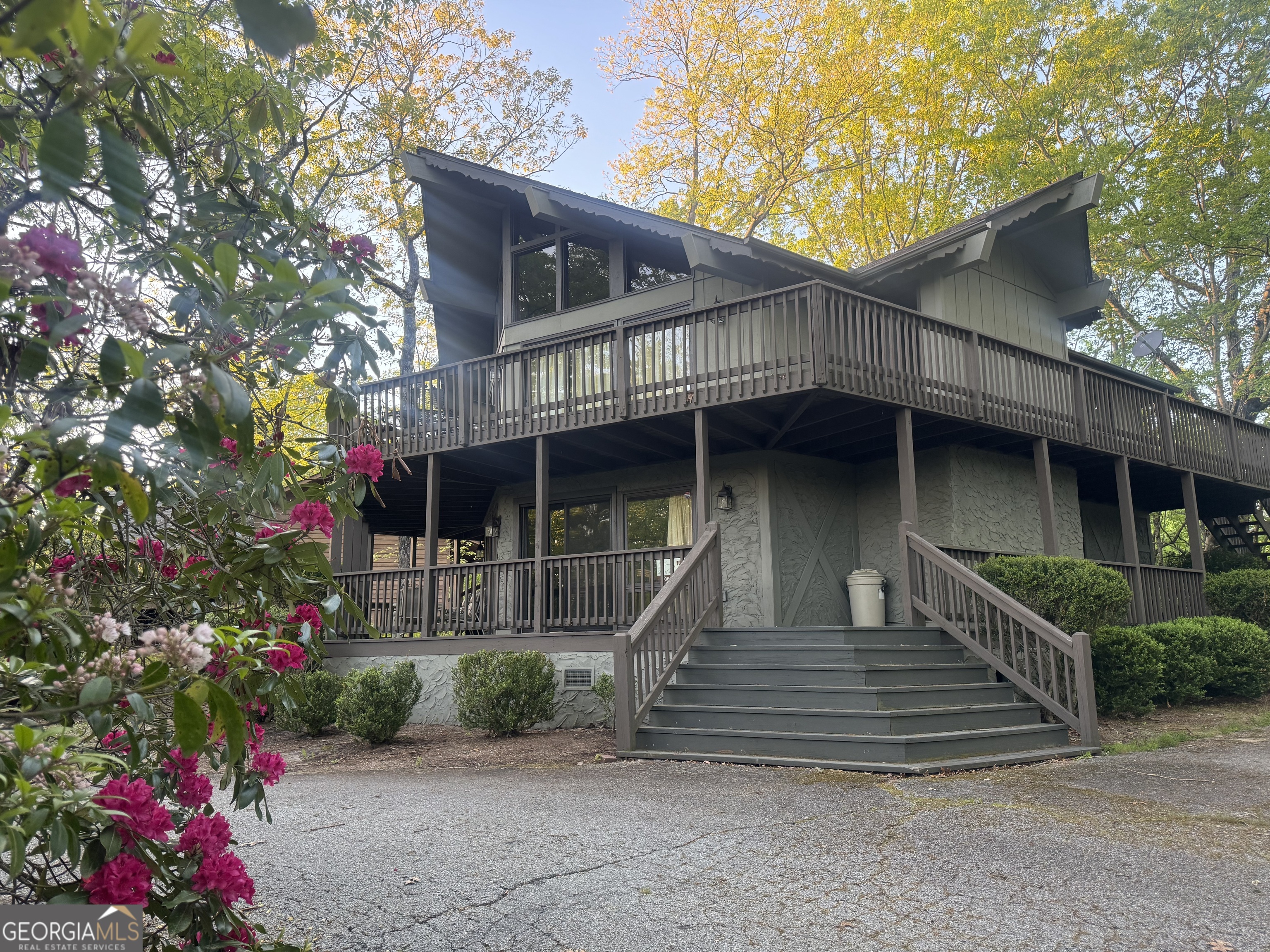 Welcome to 63 Mashie Lane, a charming furnished home nestled in the picturesque mountain community of Sky Valley, GA with an elevation over 3000 feet. This delightful property offers a perfect blend of rustic charm, cozy comfort and serene tranquility. With its unique architectural design and quiet location on a large lot near the end of a dead-end road, this property offers privacy surrounded by the natural beauty of the North Georgia mountains. Inside this spacious furnished home, you'll find two levels of open-concept living space with large windows that let the light flood in and a wood-burning fireplace, cozy and ideal for warming up on those cool chilly nights. There are three bedrooms and three full baths, including a primary ensuite on each level, providing ample space and privacy for family and guests. The kitchen features vintage appliances that still work seamlessly and a large counter space ideal for preparing delicious meals and entertaining guests. The scenic mountain views can be enjoyed from both levels with a wall of glass leading out to the expansive decks, an ideal spot for morning coffee or evening cocktails. This cabin is an entertainers dream inside and out and even includes a convenient circle driveway, offering easy access and plenty of coveted off-street parking. Located in the heart of Sky Valley, this home provides access to a range of great amenities, including a golf course, country club, pickleball courts, hiking trails, and more. Club and property owner's association memberships are optional. Sky Valley is renowned for its picturesque landscapes, high elevations, and cool temperatures, making it an ideal location for those seeking a part-time peaceful getaway retreat or a full-time permanent residence. Come see why 63 Mashie Lane is a perfect choice for those looking to embrace a cool mountain lifestyle.