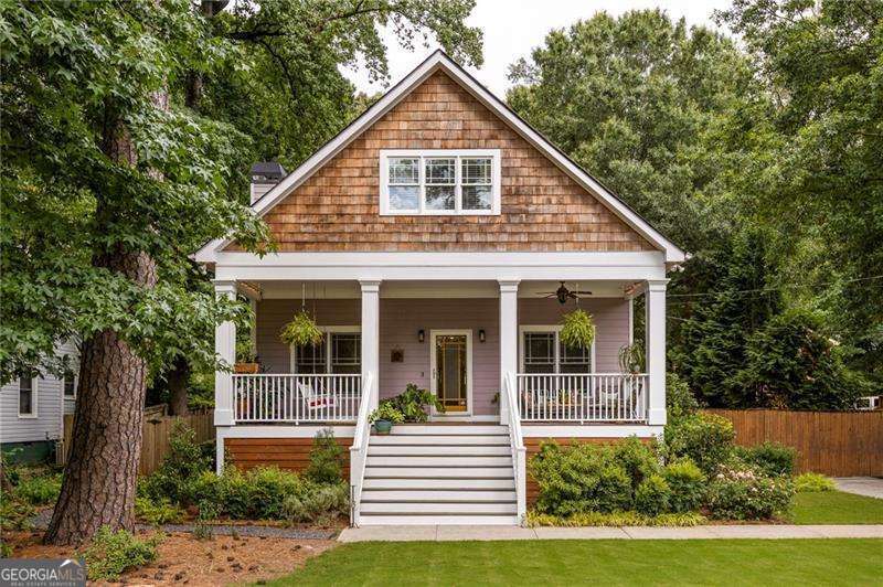 Nestled on a lively, tree-lined street, this classic Craftsman in Parkview blends timeless character with curated updates and standout curb appeal. A flat front yard and manicured landscaping lead to a wide front porch that sets an inviting tone before you even step inside. Inside, the floor plan strikes a rare balance: open and connected for everyday living and entertaining, with plenty of space to spread out and recharge. Hardwood floors, coffered ceilings, and built-in details add warmth and authenticity, while thoughtful updates keep the home feeling fresh and functional. The oversized living room features custom shelving and a cozy fireplace, flowing seamlessly into the generous dining area and bright, open kitchen. Refinished cabinetry, stainless steel appliances and a smart layout make this kitchen a true standout for everyday meals or weekend hosting. Just off the kitchen, built-in cabinetry adds stylish storage and day to day ease. Two spacious main level bedrooms and an updated hall bath offer flexibility for guests, a home office, or creative space. The elevated primary suite feels like a private retreat, complete with a fully renovated en suite bathroom featuring designer tile, clean lines, and a walk-in rain shower. Head upstairs where a full upper level renovation adds a fifth bedroom and third bathroom, plus you'll find a bonus room ideal for a playroom, media zone, or dynamic guest suite that adapts to your changing needs. Step outside through French doors to your backyard oasis. A large deck, lush landscaping, and a fully fenced yard create the perfect setting for late summer BBQs or crisp fall evenings around the fire pit. The detached two car garage offers even more storage, while a remote controlled gate adds daily convenience. Located just blocks from DeKalb Memorial Park and Disc Golf, Charlie Yates Golf Course, and minutes to I 20, this home delivers the best of intown living with the comfort and charm of a true neighborhood gem.
