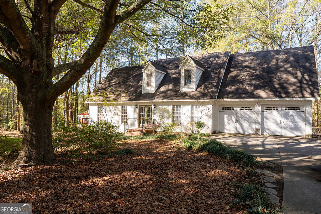 Come explore this charming one owner home with a spacious half acre lot in the sought after Hillgrove school district! Upon entering, you are greeted by beautiful hardwood floors in the foyer that flow throughout the main living area. The spacious living room offers a comfortable, inviting space to relax or entertain, an abundance of natural light, and a fireplace for those cozy winter nights. The eat-in kitchen offers ample cabinet space and solid surface countertops, and the separate dining room is perfect for entertaining. You'll also find the laundry and a full bath on the main level. Retreat upstairs to the oversized master suite with a full bath. Down the hall are two roomy additional bedrooms and an additional full bath. Outside, enjoy half an acre of land to call your own, where you can relax on the patio with a morning coffee and have an outbuilding for extra storage. This home offers a newer HVAC system and septic tank was pumped in 2023. Don't miss the opportunity to experience this slice of heaven, so close to all West Cobb has to offer AND UNDER $400K! Schedule your showing today!!!