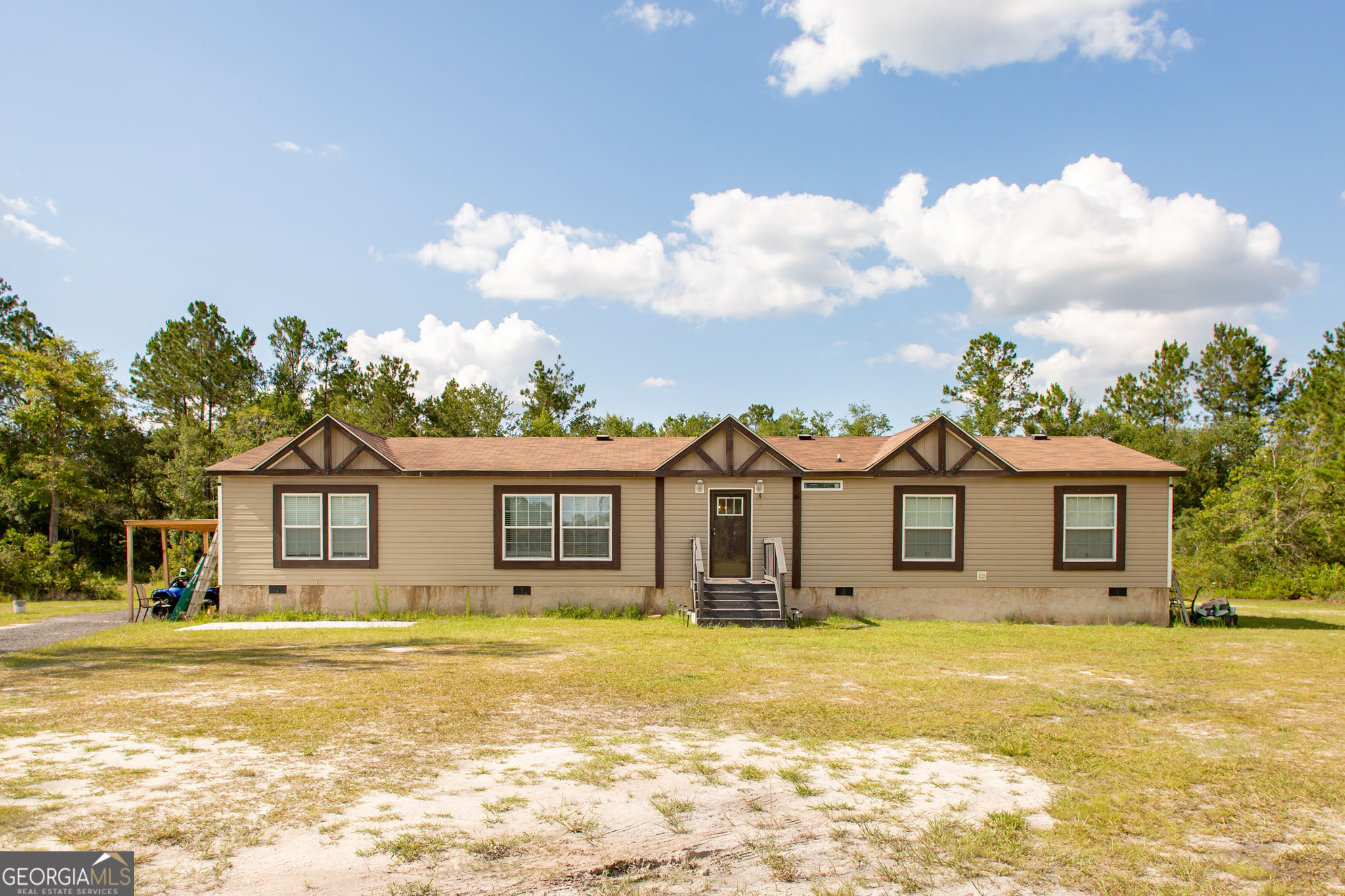 Welcome to 120 Scarlett Drive, Waycross, GA! This 2022 Scot Bilt Challenger mobile home combines modern design and spacious living on a generous 1.97-acre lot. With an impressive 32' x 76' layout, this home offers four generously sized bedrooms and two full baths, making it perfect for families or those who value extra space. Step inside to discover a thoughtfully designed open floor plan that effortlessly blends style and functionality. The living area is ideal for relaxation or entertaining, while the modern kitchen boasts quality appliances, ample cabinetry, and space for all your culinary creations. The primary suite serves as a tranquil retreat with its own private bath, while the additional bedrooms are perfect for family, guests, or a home office. The expansive lot provides endless opportunities for outdoor enjoyment, from gardening to hosting gatherings or simply enjoying the serene surroundings. This property offers the perfect combination of affordability, quality, and room to grow-all within the peaceful charm of Waycross. Don't miss your chance to call this home your own!