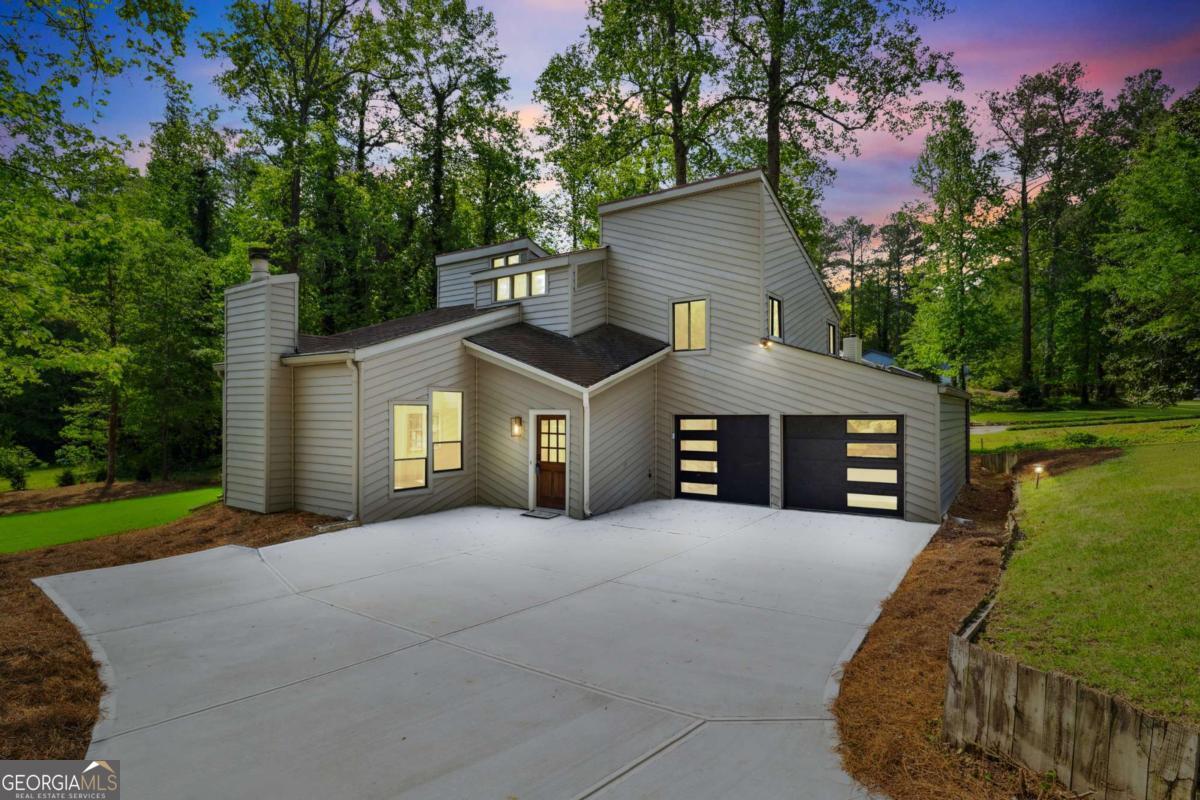 Fully renovated contemporary home in the coveted Pope High School District, just minutes from shopping, dining, parks, and only 6.8 miles from downtown Roswell. This modern stunner features a dramatic two-story family room with skylights, sleek new stair railings, luxury vinyl plank flooring with upgraded moldings, and a level backyard perfect for entertaining. The kitchen and bathrooms have been beautifully updated with soft-close cabinetry, quartz countertops, designer tile, stylish fixtures, and custom lighting. The primary suite boasts vaulted ceilings and additional skylights in both the bedroom and spa-like bath. Additional upgrades include new doors and hardware, new garage doors, a new hot water heater, recessed can lighting, and detailed trim work throughout. Located in an established neighborhood with quick access to Hwy 92, I-75, GA-400, and I-285 via Johnson Ferry-this home offers upscale East Cobb living in a prime central location.