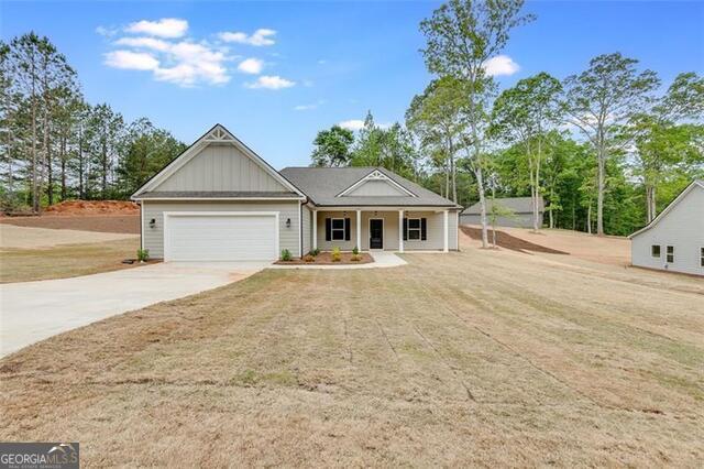 Your BRAND-NEW home is awaiting you in Mansfield (Jasper County Schools) & NO HOA. Adjacent lot (.91 acres) available to include with purchase for a total of 1.61 acres for $394,900. This home features 4 bedrooms, 2.5 bathrooms and very spacious with 2274 square feet and includes James Hardie siding, architectural shingles, 9-foot ceilings, hardwood floors in family room and kitchen, ceramic tile in baths & laundry, carpet in bedrooms, shaker style kitchen cabinets with soft close hinges, stainless appliances, granite countertops & tile backsplash, owner's suite bath with double vanity, tile shower & soaking tub. Seller is offering $4500 towards buyer's closing costs. Centrally located to Monticello, Covington & Jackson & just 2 miles from Bear Creek Marina at Jackson Lake. Contact your Realtor to schedule your private showing today.