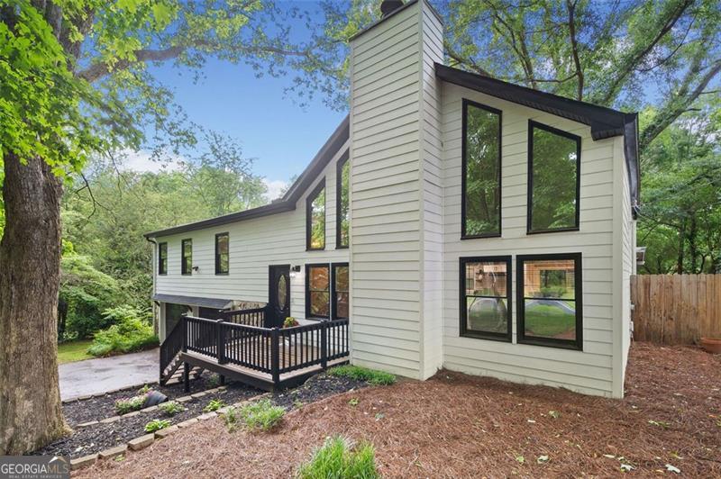 Beautiful Updated Home with Bonus Room on Large Wooded Lot -Golf Cart Distance/2.5 miles to Downtown Woodstock! This Beautiful Updated 4BR/2BA Home Offers A Flexible 5th Bedroom/Media Room/Teen Suite. Dream Kitchen Features - White Cabinets, Quartz Countertops, Tile Backsplash, Open Shelving & Stainless Steel Appliances. Eat-In Dining Area. Large-Two Story Living Room with Vaulted Ceiling Has Many Windows That Bring in Abundant of Natural Light. Large Master Bedroom. Master Bath with Barn Door, Walk-in Tile Shower, Double Vanities, Tile Flooring. His & Her Walk-In Closet with Built in Shelving. Spacious Secondary Bedrooms. Updated Hall Bath. Finished Terrace Level. Screen Porch. Huge Fenced Backyard. Large Wooded Lot. Great Schools! Quite Neighborhood! Close to Kings Academy & Cherokee Christian Academy Schools. Home is Move-In Ready! Don't Wait!