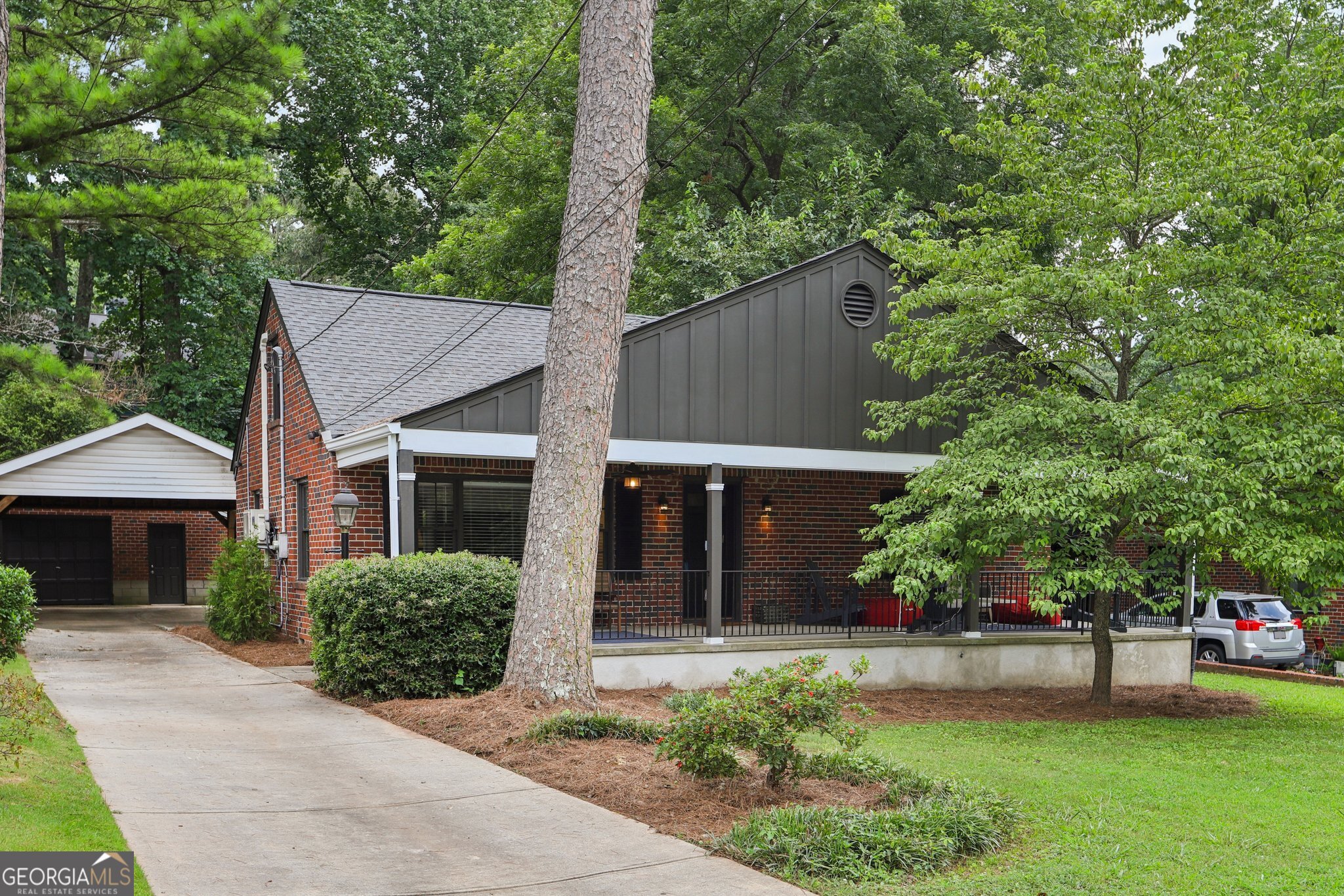 Beautifully Updated Home with Southern Charm and Modern Touches! This beautifully updated home offers bright, open spaces and timeless appeal. A sprawling Southern-style front porch stretches across the entire length of the house-perfect for rocking chairs and enjoying cool Georgia evenings. Step inside to find gorgeous hardwood floors throughout-no carpet anywhere! The sun-filled living room flows into a separate dining area, ideal for entertaining. The modern kitchen is a standout, featuring unique painted cabinetry, butcher block countertops, stainless steel appliances, and a pass-through to the sunroom that doubles as a stylish bar area. The main-level primary bedroom has convenient en-suite access to a fully updated hall bath. A second bedroom is located just across the hall. Upstairs, you'll find two generously sized bedrooms and another beautifully updated full bath, offering plenty of space for everyone! Out back, enjoy an oversized deck-perfect for grilling, entertaining, or relaxing under the trees. The detached garage with an oversized attached carport has ample parking and adds convenience, while the large, flat backyard offers mature trees for privacy and endless possibilities for outdoor fun. Updates include: renovated kitchen, new roof, brand-new deck, tankless water heater, and a new AC unit (2025). All located close to parks, top-rated schools, and local shopping and dining. Don't miss your opportunity - book your tour today!