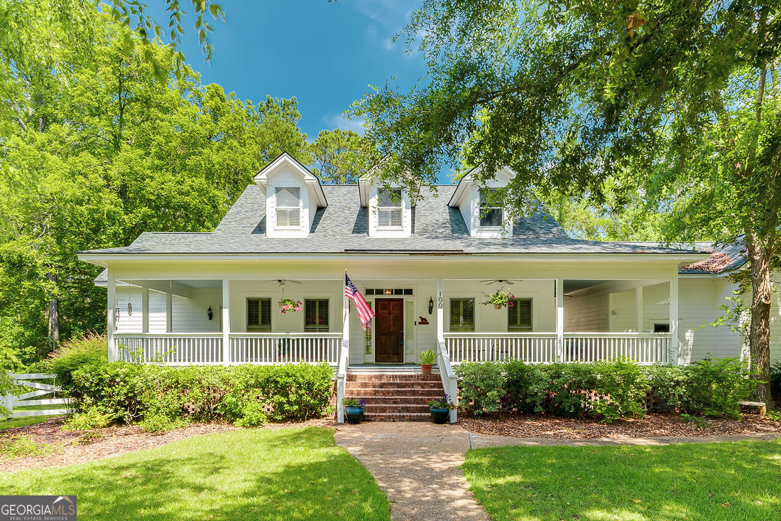 Experience Low Country elegance in this custom estate on a private, multi-parcel lot in Rincon. The main level features a great room with fireplace and second-story screened porch, a chef's kitchen with high-end finishes, and an owner's suite with spa-like bath, walk-in closet, and tranquil backyard views. Two additional rooms offer flexibility for offices or a den. Upstairs, two bedrooms each have private baths and walk-in closets. The finished walk-out basement includes a cozy den with fireplace, plus a bonus bedroom and full bath-ideal for guests or multi-generational living. Outdoor living shines with a wrap-around porch, multi-level composite deck, and outdoor kitchen. A detached garage/workshop includes enhanced power and an additional bedroom and full bath above, not counted in the advertised square footage. Nestled among mature trees in a pool-equipped community, this Southern gem offers exceptional space, privacy, and charm. Offered with all 3 lots in one purchase.