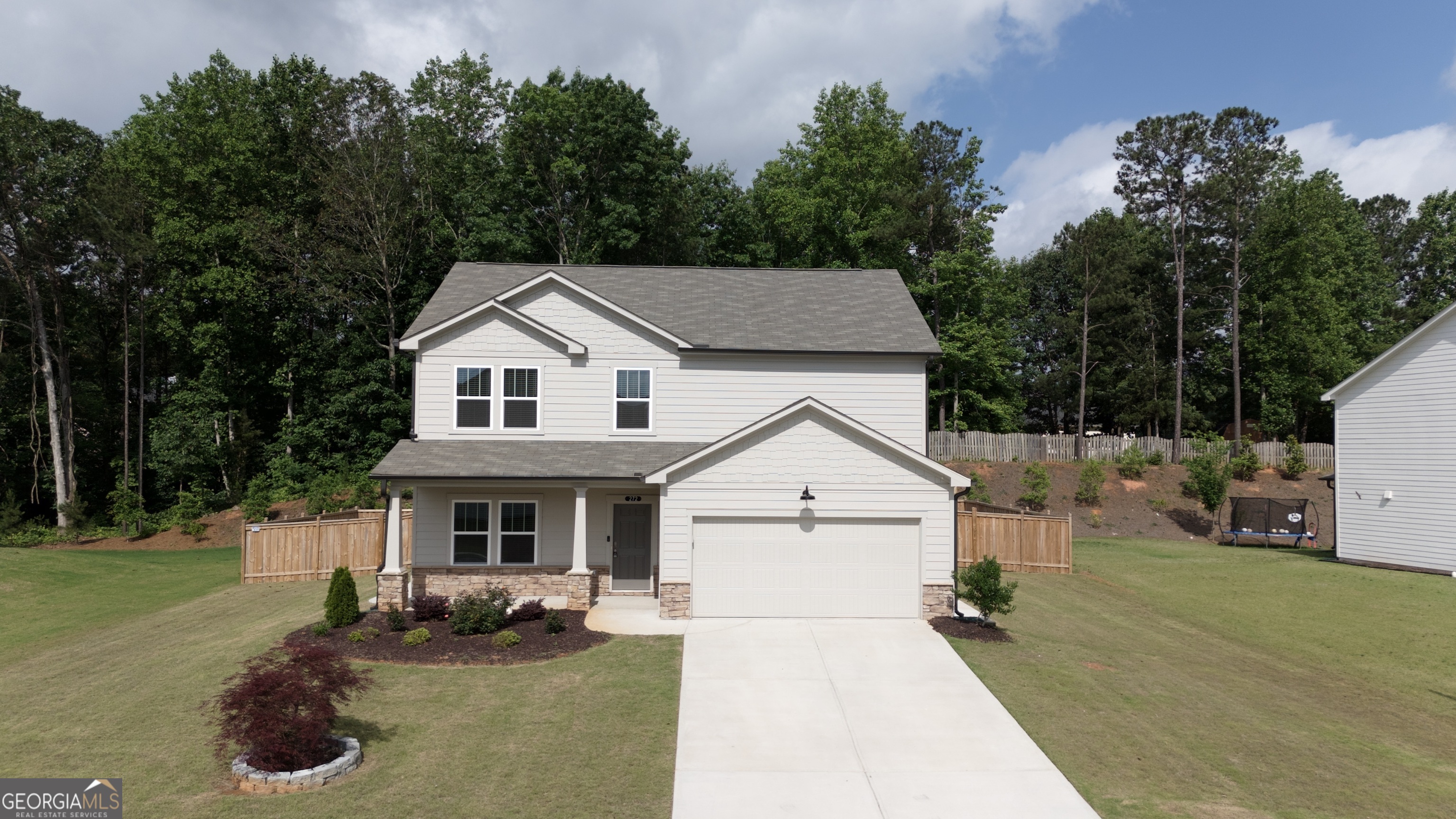 This stunning 4-bedroom, 2.5-bathroom home in Acworth, GA offers modern living with over $60k in high-end upgrades throughout. Situated on a premium level lot, it features a fully fenced backyard, spacious storage shed, and newly installed concrete pathways. Inside, you'll find luxury vinyl plank flooring throughout the whole house, a dedicated office space on the main floor, and an inviting sunroom. The open-concept living area includes a cozy fireplace flanked by custom-built-in shelves. Upstairs, a versatile loft provides the perfect space for entertainment or relaxation. The gourmet kitchen is a chef's dream-complete with granite countertops, white subway tile backsplash, KitchenAid appliances, and stylish modern fixtures. The oversized primary suite features a generous walk-in closet and a spa-like bathroom with double vanities, a soaking tub, and a frameless glass shower. Additional features include a tankless water heater, updated lighting, and thoughtful details throughout. This move-in ready home blends comfort, style, and functionality-all in a prime Acworth location near top schools, shopping, and parks.