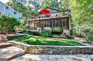 Lake life awaits at 572 Lake Drive in Snellville's desirable private Norris Lake community. This charming 2-bedroom, 2-bath home sits on a 0.4600-acre lot and offers direct access to a private lake right in your backyard, creating a rare opportunity to enjoy a true lakeside oasis just 45 minutes from Downtown Atlanta and 15 minutes from Downtown Snellville. With its blend of natural beauty, outdoor recreation, and everyday convenience, this property offers the best of both worlds. Designed for lake life, this property features multiple outdoor spaces that maximize enjoyment and entertaining. An expansive deck off the living and dining room is perfect for grilling and hosting gatherings with friends and family. From the screened-in porch off the basement, you can relax while enjoying fresh air and lake views in any weather. Gather around the lakeside fire pit or entertain on the terraced backyard right by the water-with a private dock and boat slip, it's easy to head out for boating, fishing, or simply floating. This home truly allows you to live, relax, and entertain right on the lake. Inside, you'll find an inviting open-concept layout where the kitchen, dining room, and living room flow seamlessly together-perfect for both everyday living and entertainment. The kitchen is appointed with stainless steel appliances, and the main living room features a fireplace and beautiful vaulted ceilings. On the main level, you'll find two spacious bedrooms, including a primary suite with a walk-in closet and a spa-like bath featuring a walk-in shower. A secondary bedroom provides flexibility for guests, a home office, or additional living space. The finished basement provides a flexible second living area complete with its own fireplace and full bath, making it ideal for a den, media room, or guest retreat. This level also includes a one-car garage with ample storage space and a laundry room, adding convenience and functionality to everyday living. The backyard is a true highlight of this home, thoughtfully designed with lush greenery, mature trees, and layered landscaping that enhance its peaceful retreat-like setting. A koi pond adds to the charm, while the mix of sunny and shaded spaces creates the perfect environment for relaxing, entertaining, or simply enjoying nature right at your doorstep. The Norris Lake community enhances the lifestyle with resort-style amenities: a private beach, community dock, swimming pool, tennis courts, playground, and clubhouse-all centered around a scenic private lake where neighbors come together. Residents also enjoy a monthly garden club to maintain the community's landscaped beds, volunteer days for community projects, monthly member meetings, the lively "First Friday Club" where neighbors gather to eat, listen to music, and socialize, and a book club for avid readers. If you've been dreaming of a home that offers both peaceful seclusion and easy access to Atlanta, this property delivers. With direct lake access, lush landscaping, versatile living spaces, and a welcoming community with vibrant social and volunteer opportunities, it's the perfect balance of recreation, relaxation, and connection.