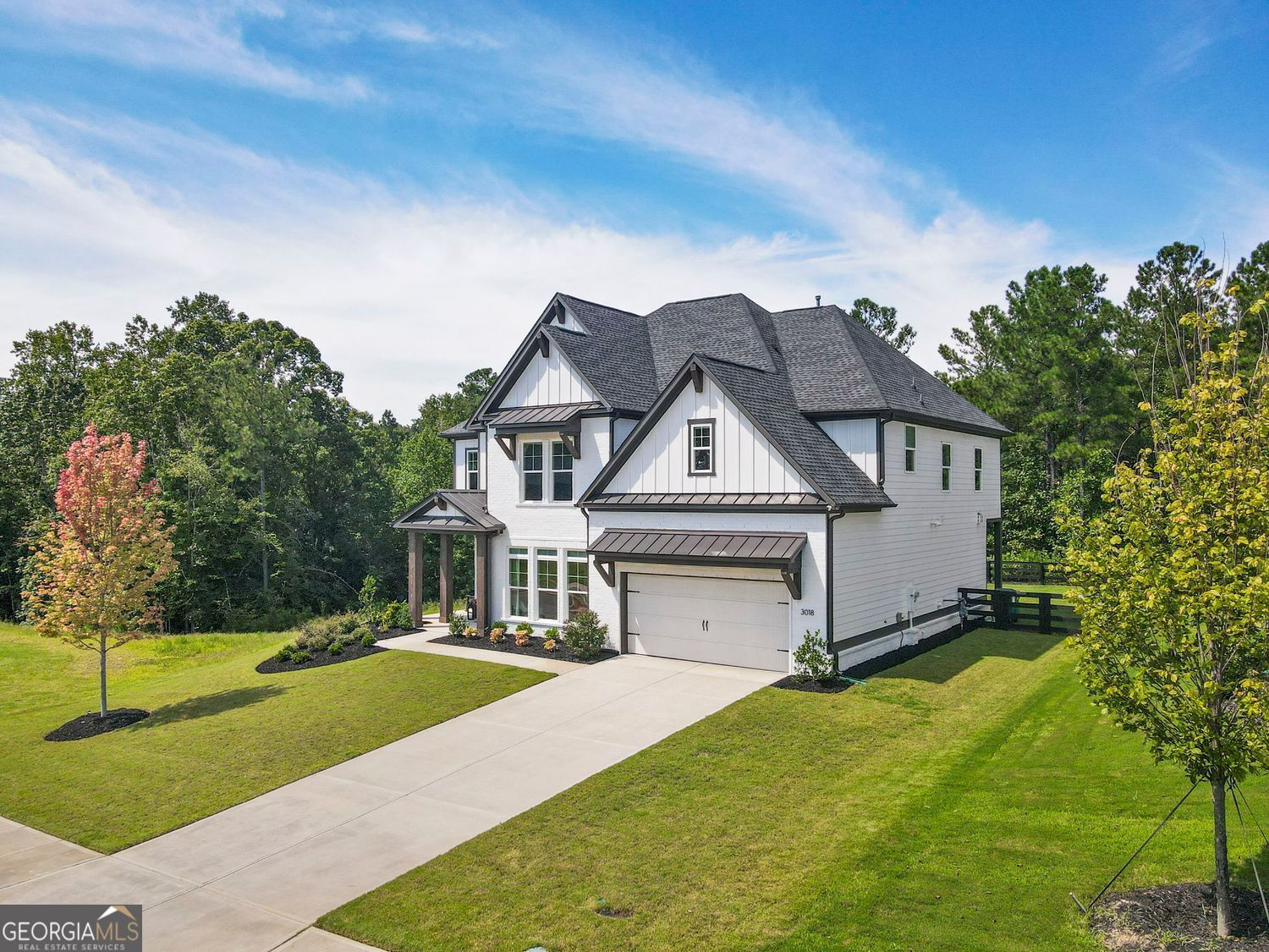 Situated just beyond the Milton line, this beautifully upgraded home combines timeless style with everyday functionality. A dramatic two-story great room anchors the open floor plan, which also includes a private office with custom double doors, formal dining room, and a gourmet kitchen with custom cabinetry, oversized island, and premium appliances. The walk-out backyard is fully fenced and professionally landscaped. Upstairs, the primary suite offers a spacious retreat with custom closet and a fully renovated bath boasting dual vanities, soaking tub, and upgraded shower. Additional highlights include custom built-ins, a thoughtfully designed mudroom, upgraded hardwood floors throughout, and a beautifully updated first-floor full bath. Blending pastoral charm with modern convenience, this residence offers a rare opportunity to enjoy refined living just minutes from Atlanta National Country Club, Milton, Alpharetta, and Woodstock's best amenities.