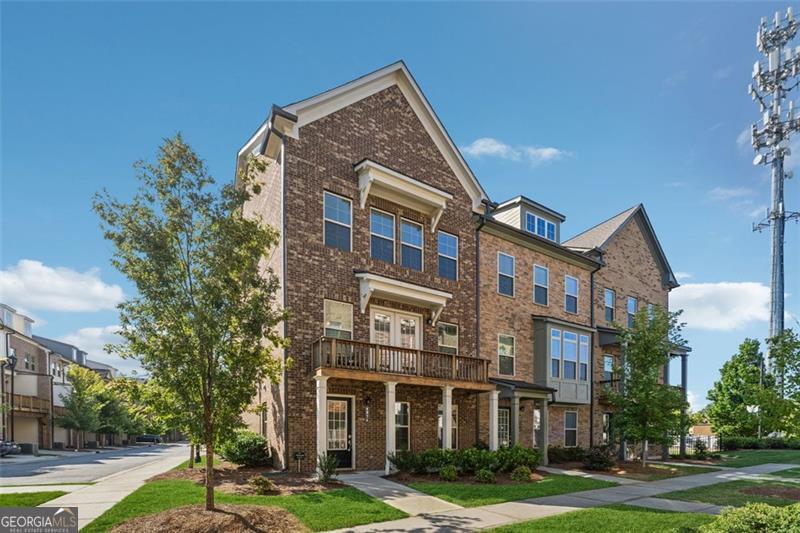 New on Market! OPEN 2-4 Sunday 9/14 A rare opportunity to own a stunning end unit townhome in the coveted 5200 at Town Center community, ideally located in the heart of Peachtree Corners and directly across from The Forum. Ranked #1 in Georgia on Fortune's 50 Best Places to Live for Families, this residence offers an unmatched lifestyle of convenience, walkability, and luxury. Step outside your door and find yourself immersed in a vibrant town center with access to the town green, playground, dog park, movie theater, boutique shops, and top-tier restaurants-all just moments away. The pedestrian bridge to The Forum adds even more shopping and dining options to your daily routine. Zoned for the highly acclaimed Simpson Elementary School, this home is perfect for families seeking both quality education and a dynamic community. Inside, Lennar's Bayfield floorplan showcases 10-foot ceilings and wide 7-inch plank LVP flooring throughout, creating a spacious and modern ambiance. The living room features custom built-ins and opens to a large deck-ideal for entertaining nearly year-round. The chef's kitchen is a showstopper, with a massive granite island, white shaker-style cabinetry, built-in oven and convection mic, gas range, stainless steel appliances, and a walk-in pantry. Overlooking the kitchen is a generous dining area complete with, butler's pantry, and elegant chandelier. A convenient half bath rounds out the main level. Upstairs, the owner's suite offers a peaceful retreat with a spa-inspired bathroom and walk-in closet, while two additional bedrooms share a full bath. The lower level adds versatility with an entry foyer, a fourth bedroom that can double as a home office, a full bathroom, and a drive-under garage Still covered under Lennar's structural warranty for six more years, this townhome combines peace of mind with upscale living. With its unbeatable location and thoughtful design, this home won't last long-schedule your showing today!